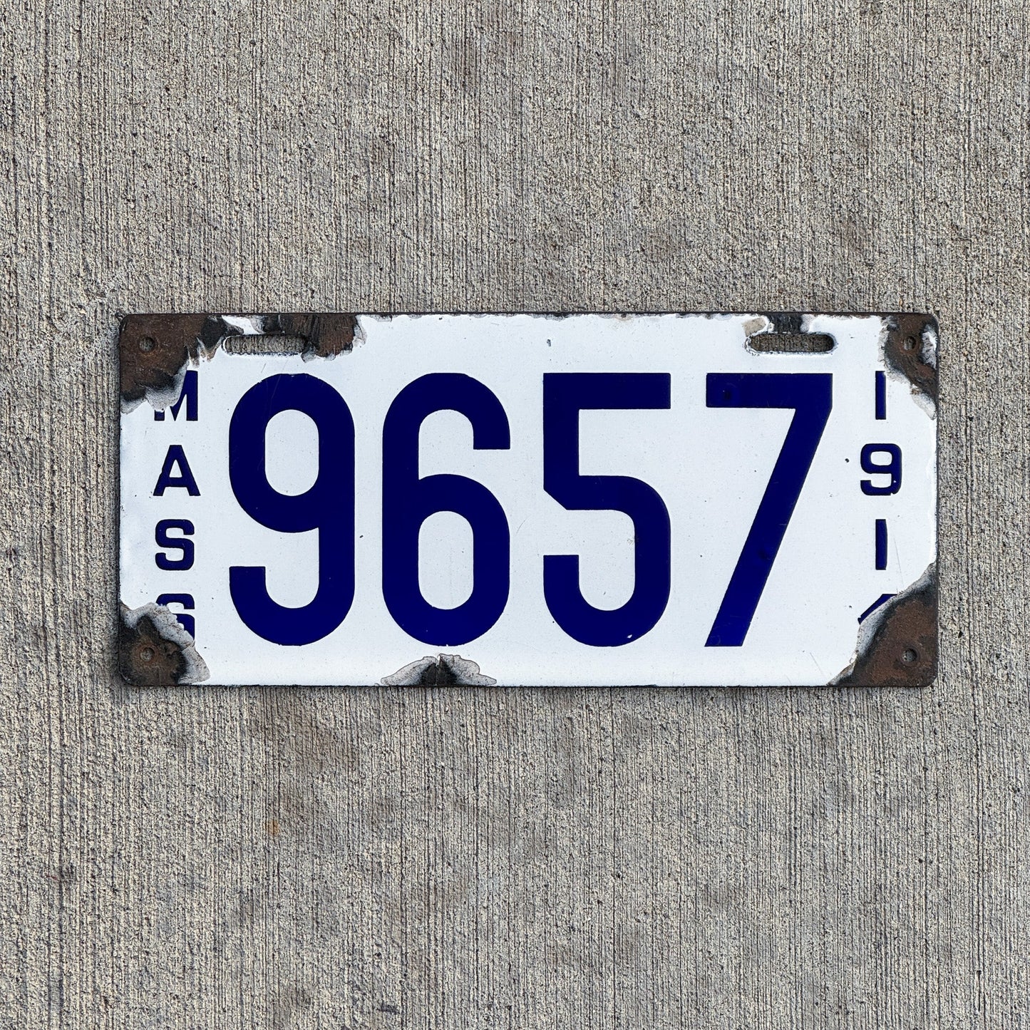 Photo of a 1914 Massachusetts Porcelain License Plate Auto Tag 1 Vintage Garage Low Number Four Digit 9657 with original patina