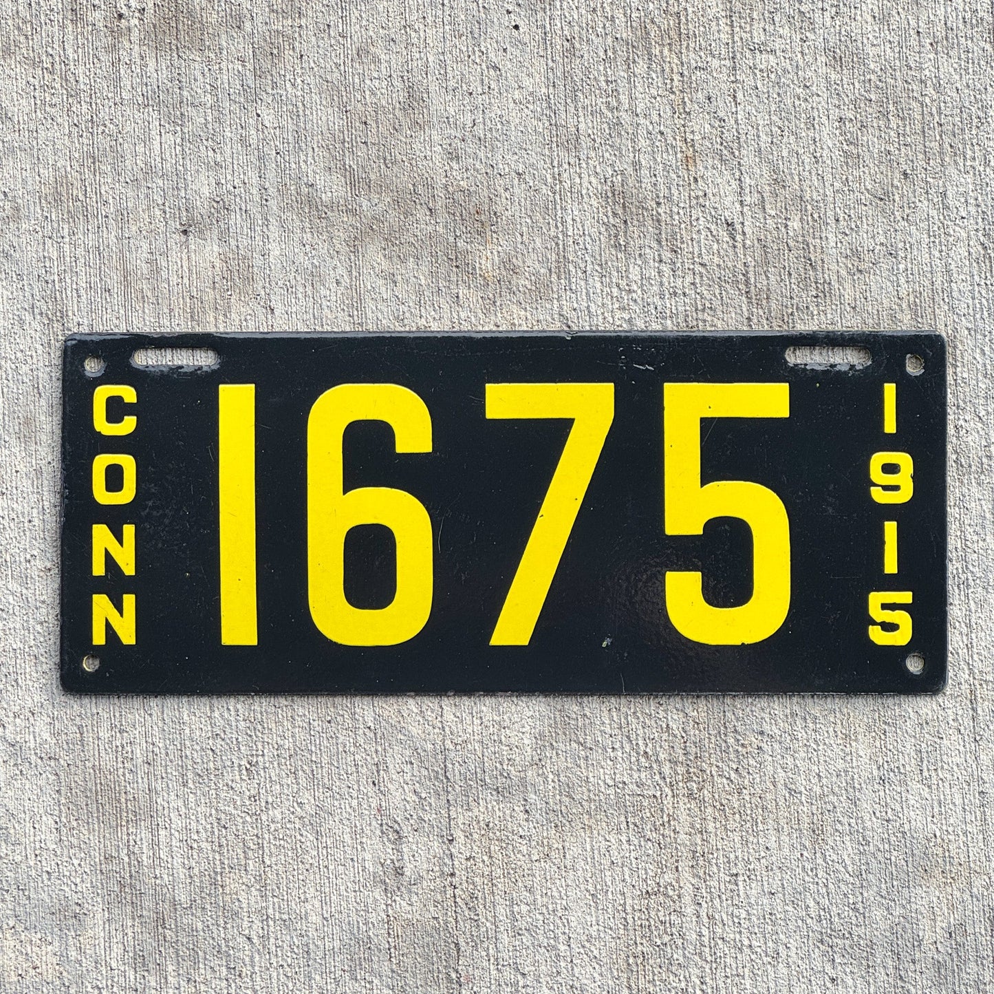 Photo of a 1915 Connecticut Porcelain License Plate Auto Tag 1 Vintage Garage Low Number Four Digit High Quality 1675 with original patina