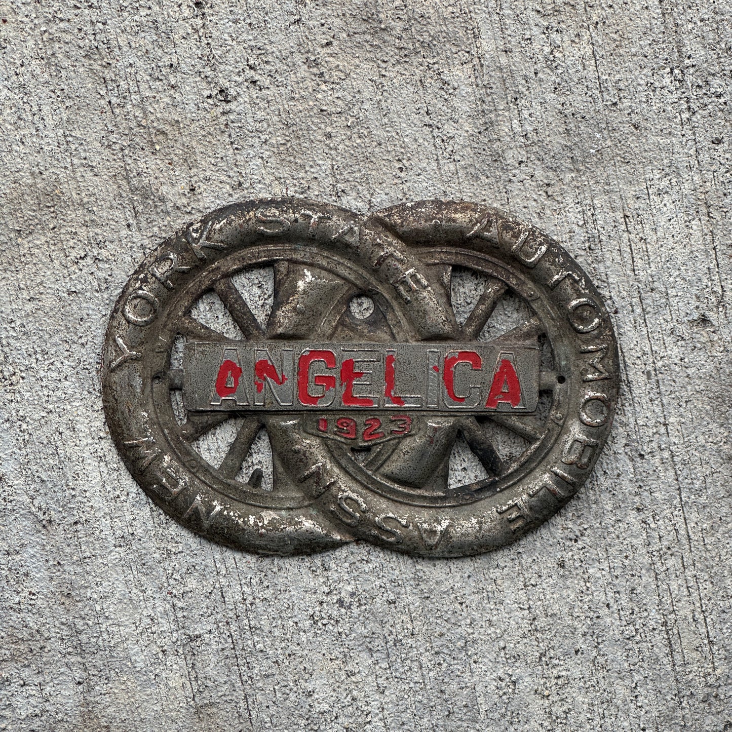 Photo of a 1923 Angelica New York Badge Emblem License Plate Topper Auto Tag Garage Decor Vintage Motor Club with original patina