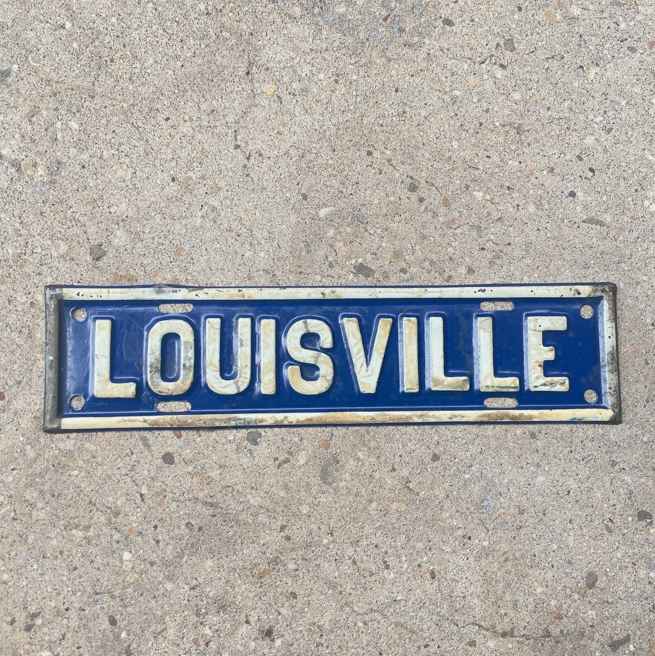 Photo of a 1930 Era Louisville Kentucky License Plate Topper Auto Tag Garage Decor Vintage KY Blue White Embossed Car Auto with original patina
