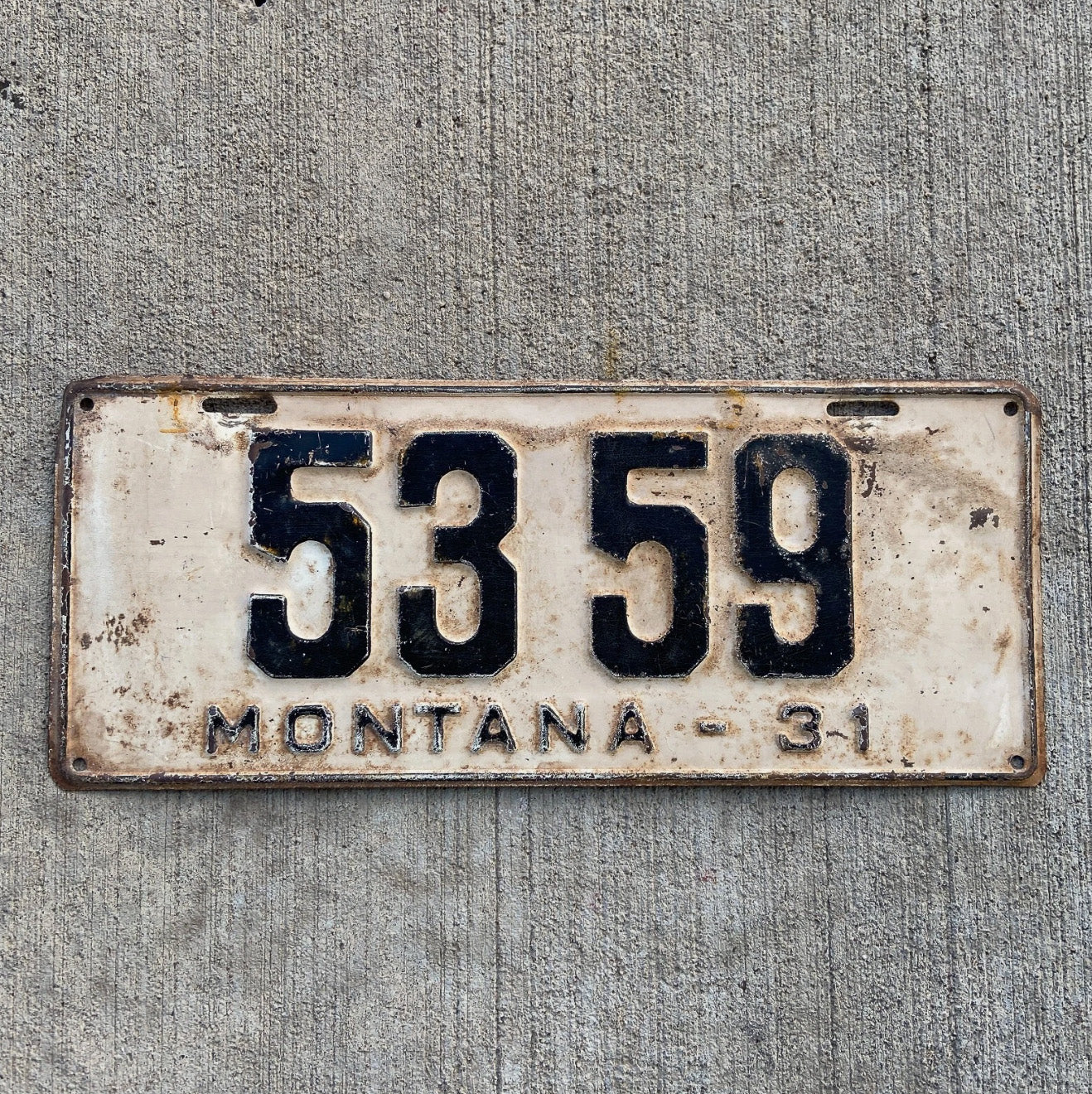 Photo of a 1931 Montana License Plate Auto Tag Garage Decor Vintage Ford Model A Year Low Number Four Digit 5359 with original patina