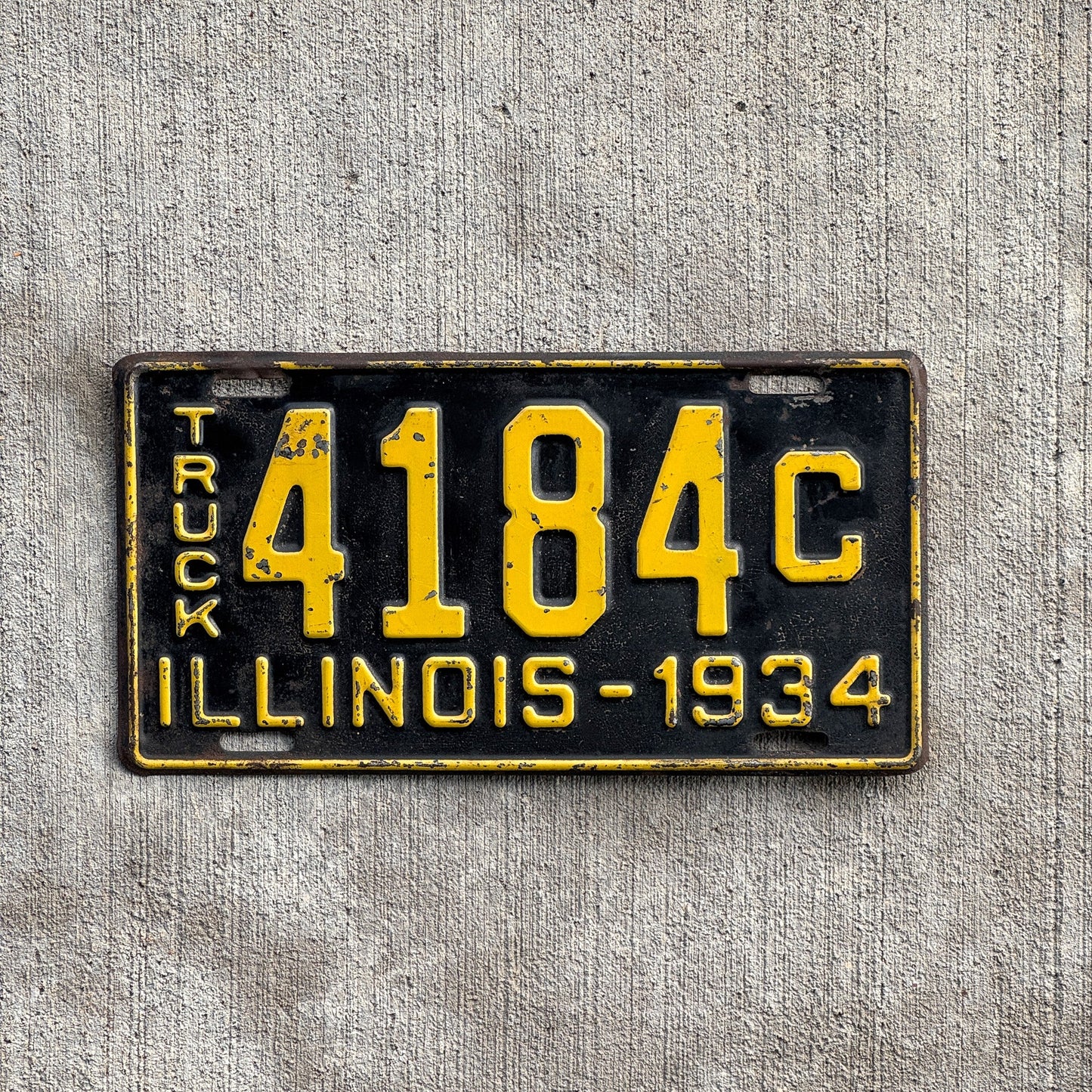 Photo of a 1934 Illinois Truck License Plate Auto Tag Garage Decor Vintage 4184 C with original patina