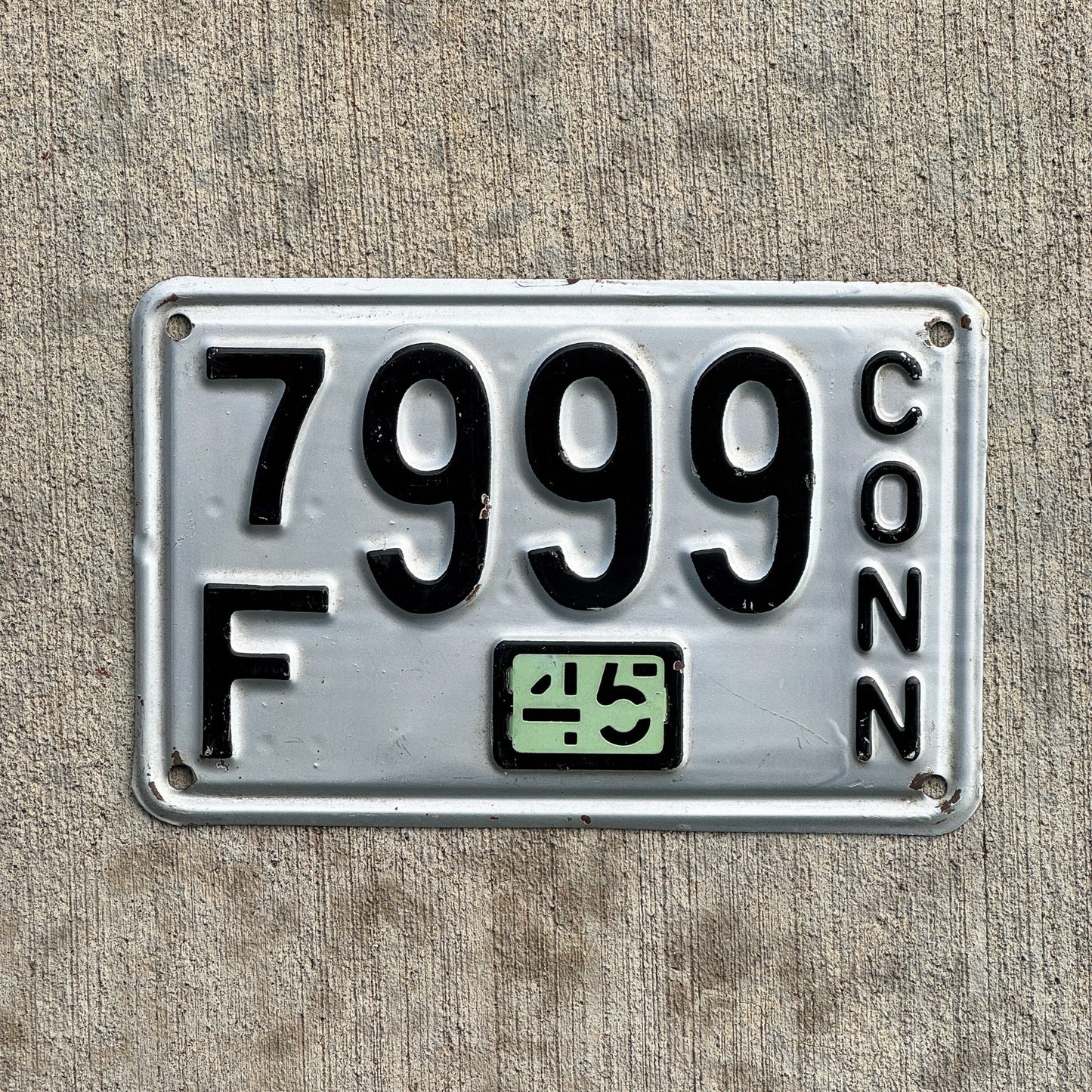 Photo of a 1937 1945 Connecticut License Plate Auto Tag Garage Decor Vintage Repeat Repeating 7F 999 with original patina