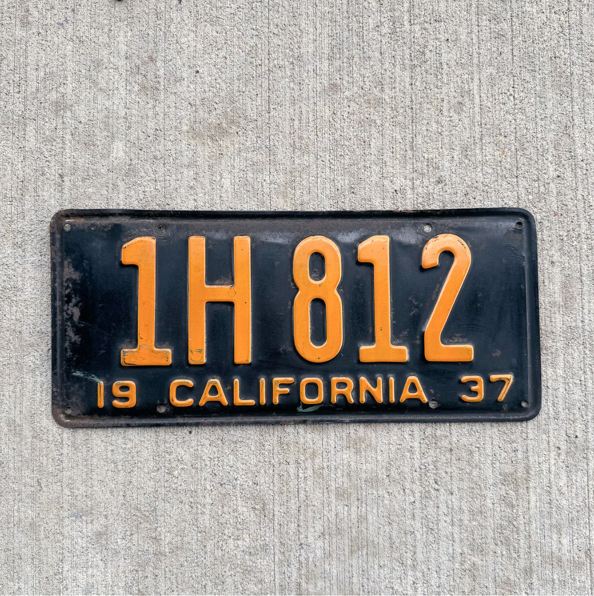 Photo of a 1937 California License Plate Auto Tag Garage Decor Vintage 1H 812 with original patina
