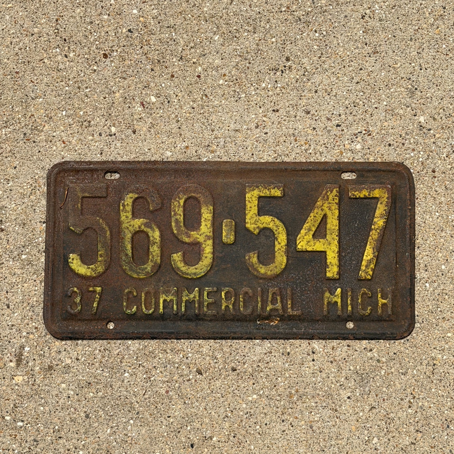 Photo of a 1937 Michigan Commercial License Plate Auto Tag Garage Decor Vintage 569 547 with original patina