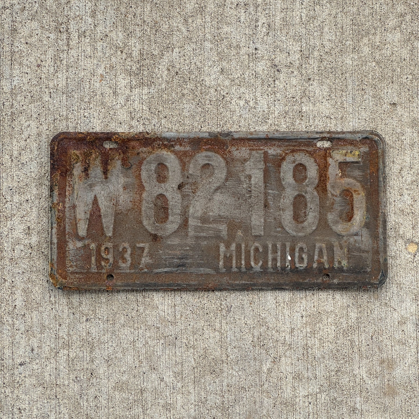 Photo of a 1937 Michigan License Plate Auto Tag 1 Vintage Garage W 82185 with original patina