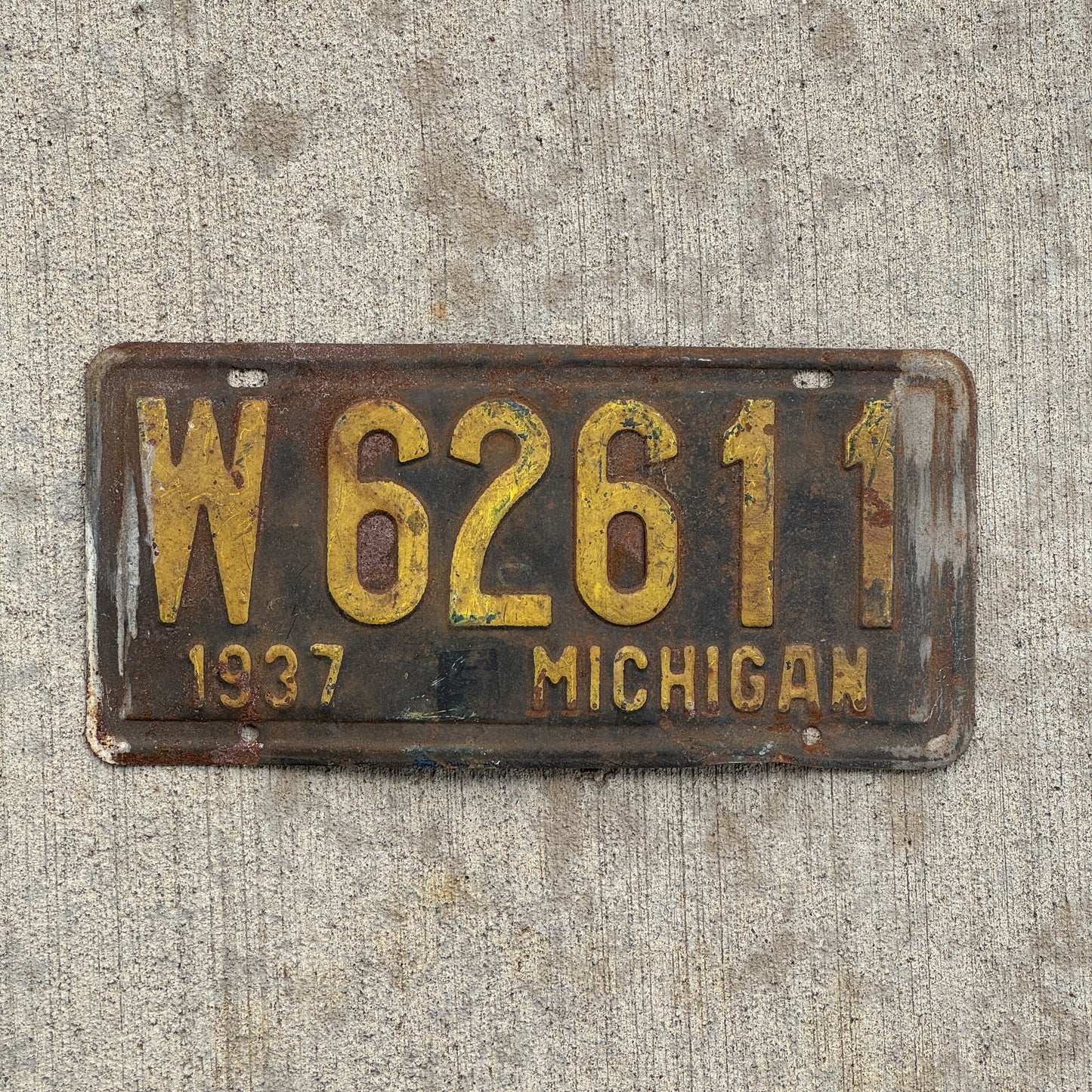 Photo of a 1937 Michigan License Plate Auto Tag Garage Decor Vintage W 62611 with original patina
