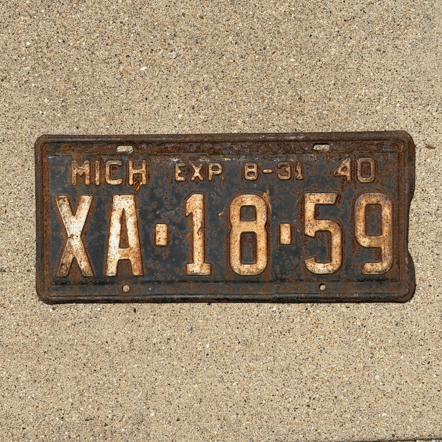 Photo of a 1940 Michigan License Plate Auto Tag Garage Decor Vintage Half Year XA 18 59 with original patina