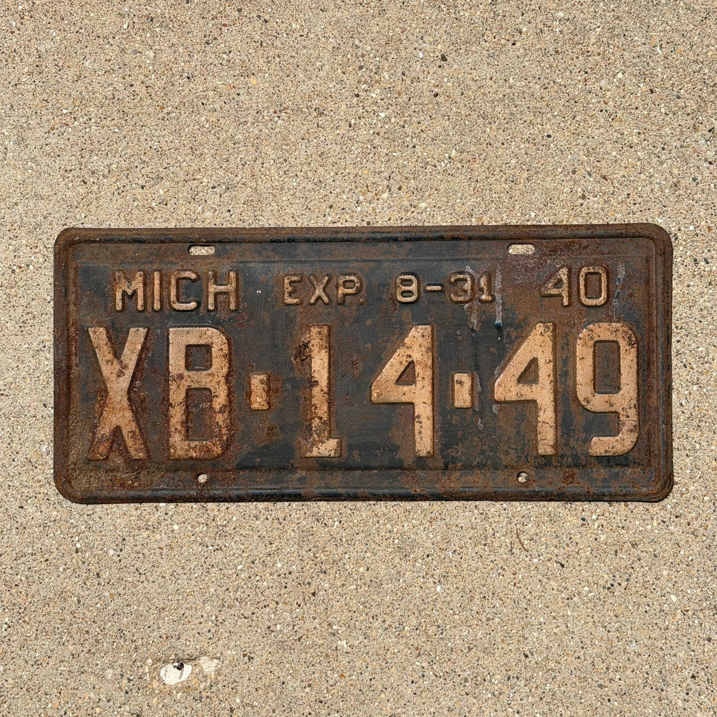 Photo of a 1940 Michigan License Plate Auto Tag Garage Decor Vintage Half Year XB 14 49 with original patina