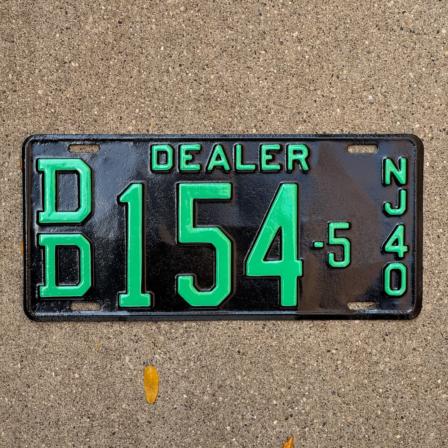 Photo of a 1940 New Jersey Dealer License Plate Auto Tag Garage Decor Vintage DD 154 5 with original patina