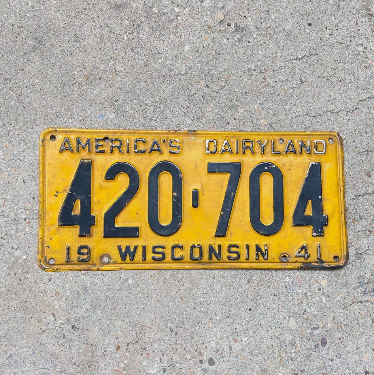 Photo of a 1941 Wisconsin License Plate Auto Tag Garage Decor Vintage Weed Smoke 420 704 with original patina