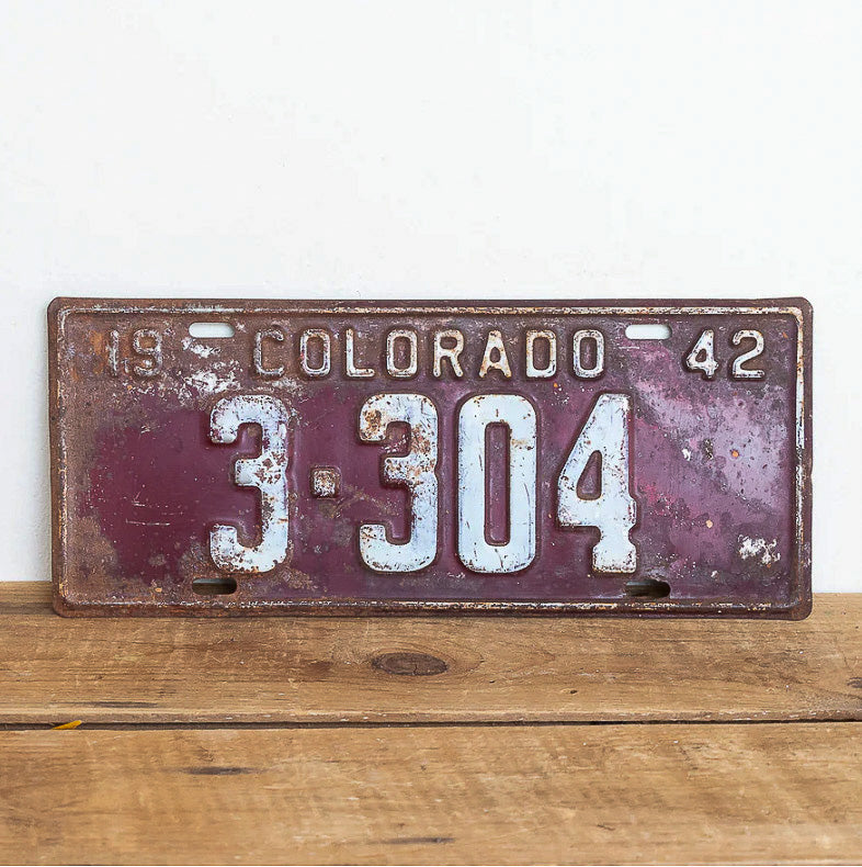 Photo of a 1942 Colorado License Plate Auto Tag Garage Decor Vintage Four Digit Low Number 3304 with original patina