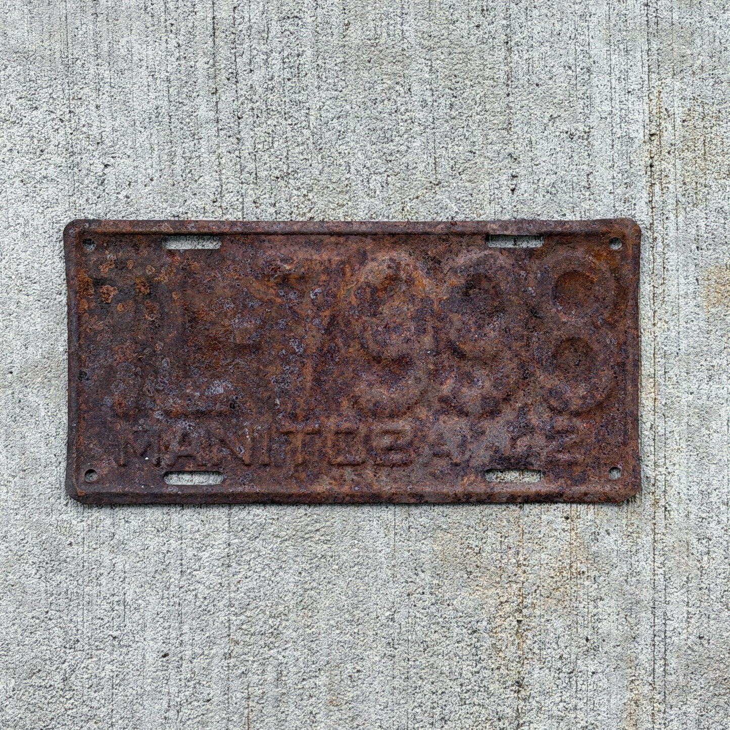 Photo of a 1942 Manitoba Trailer License Plate Auto Tag Garage Decor Vintage TL 7998 with original patina