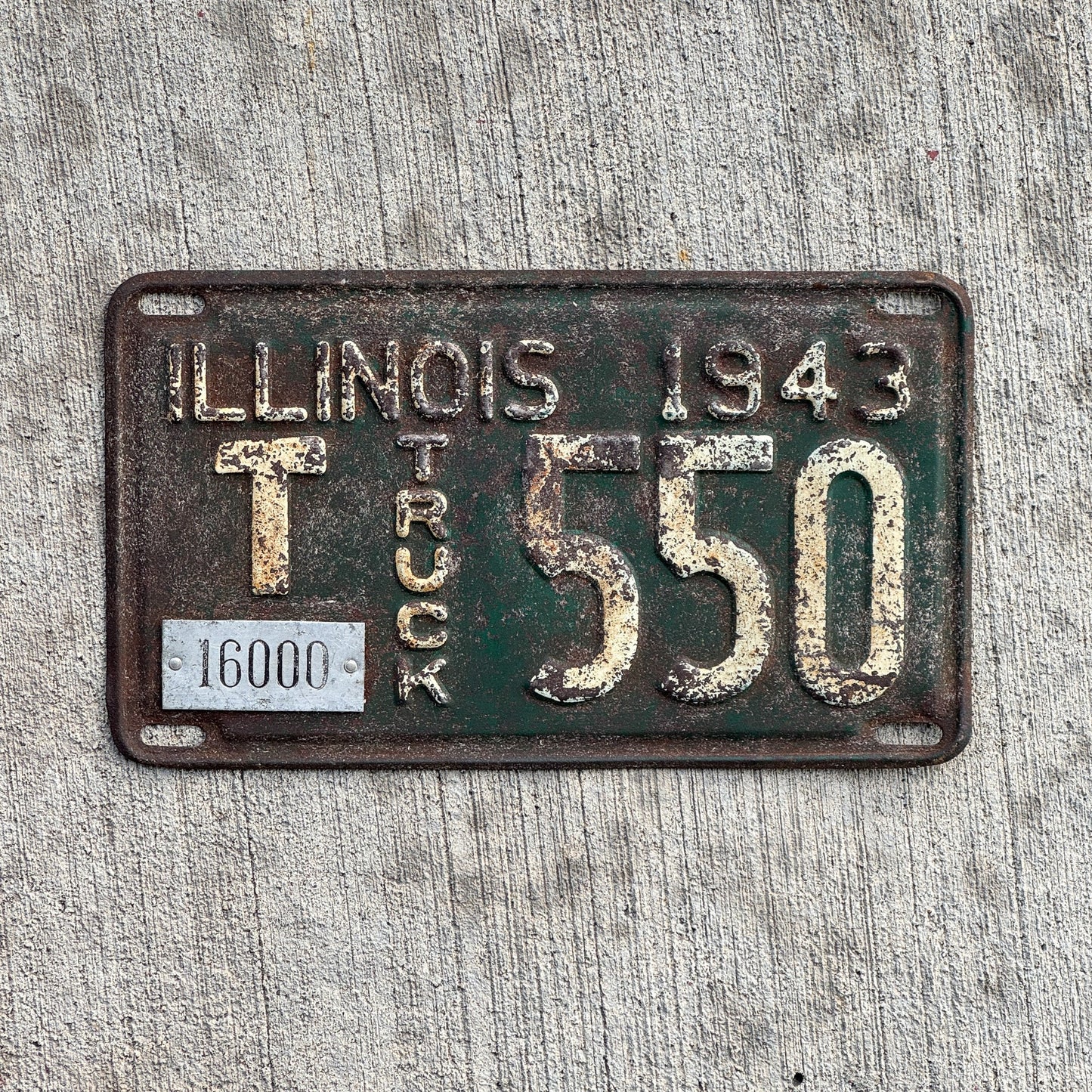 Photo of a 1943 Illinois Truck Mileage Tax License Plate Auto Tag Garage Decor Vintage Low Number Three Digit T 550 with original patina