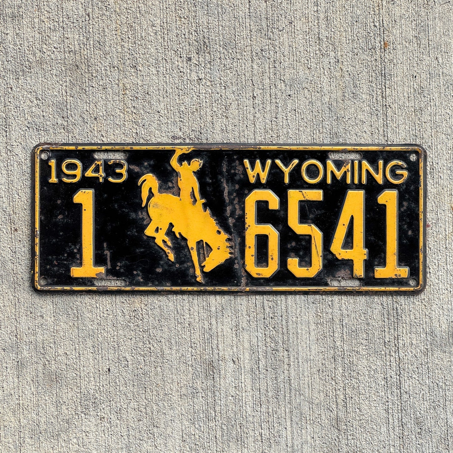 Photo of a 1943 Wyoming License Plate Auto Tag Garage Decor Vintage Cowboy Bronco Graphic 1 6541 with original patina