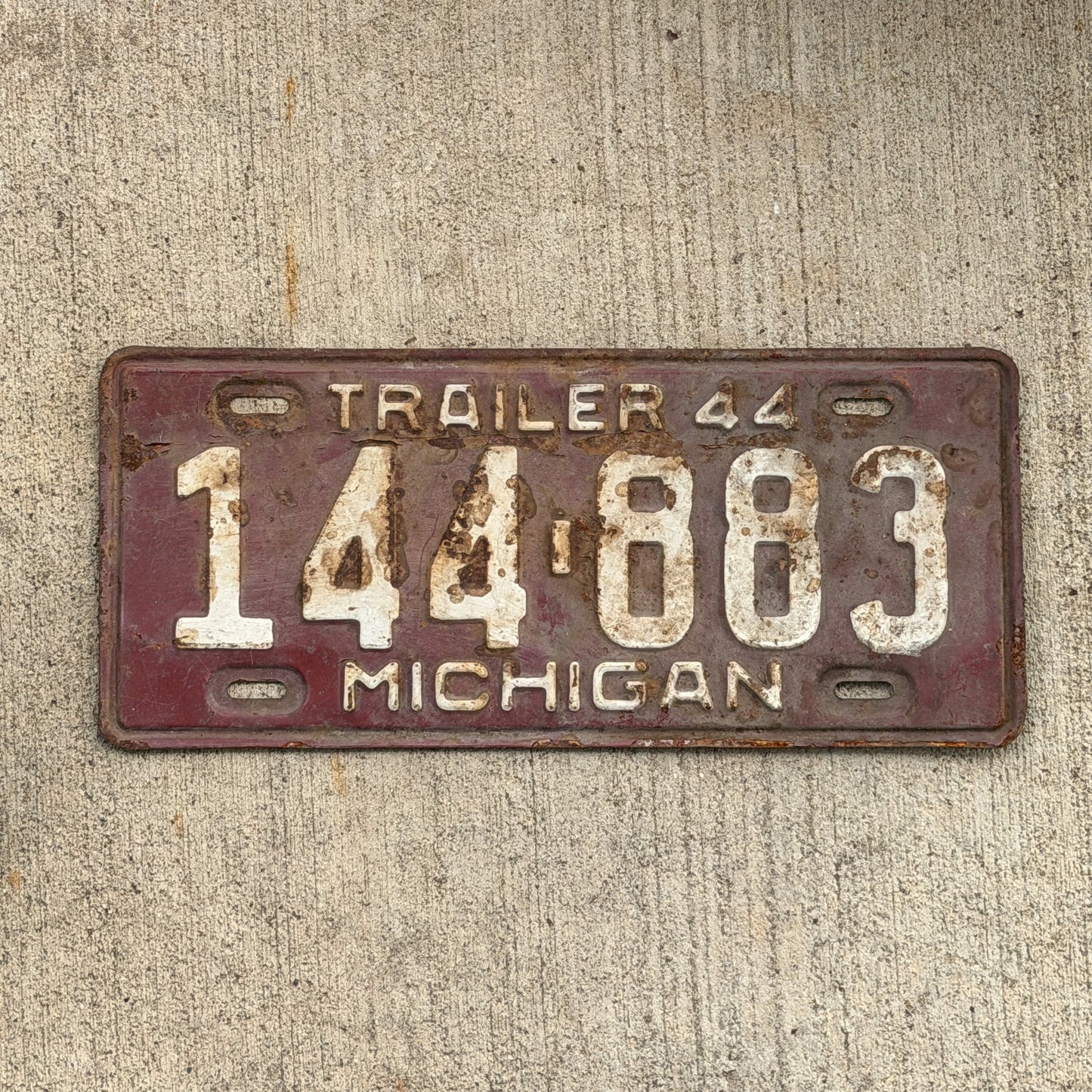 Photo of a 1944 Michigan Trailer License Plate Auto Tag Garage Decor Vintage 144 883 with original patina