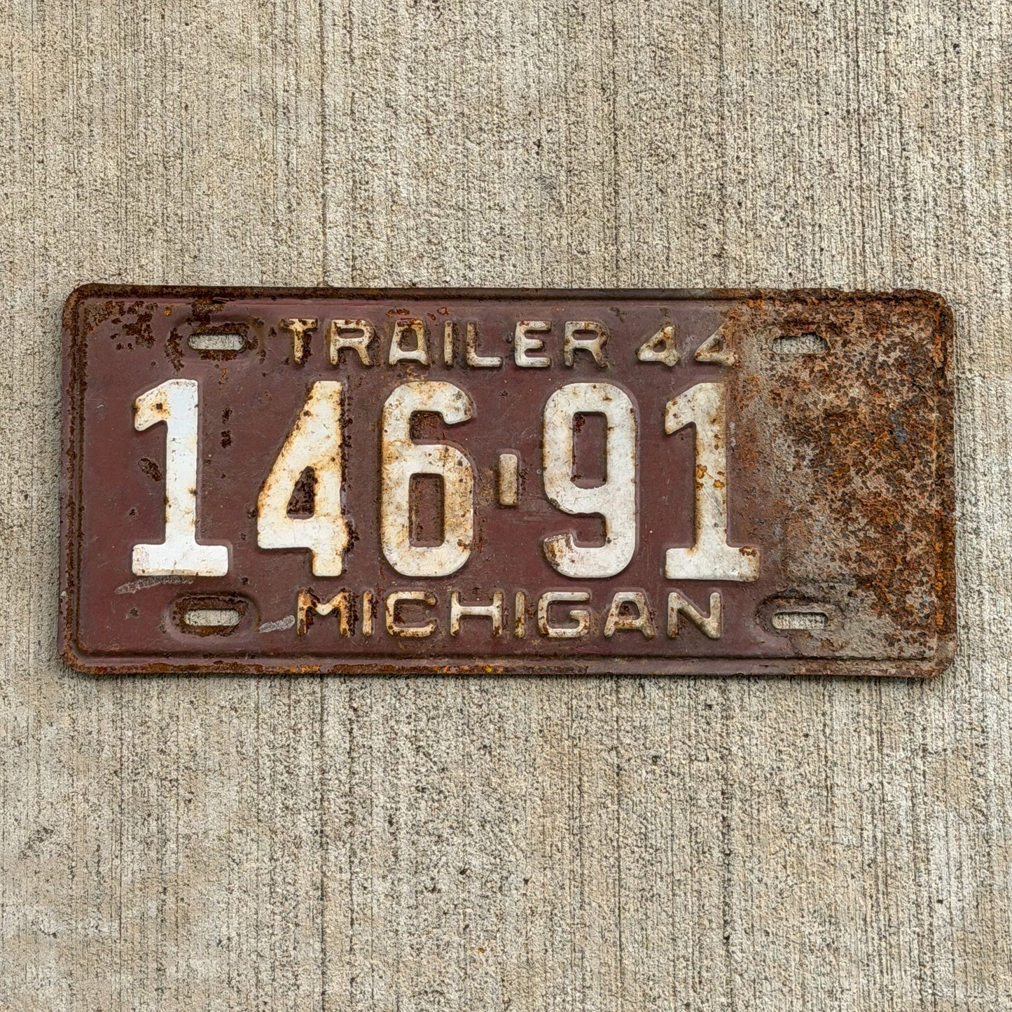 Photo of a 1944 Michigan Trailer License Plate Auto Tag Garage Decor Vintage 146 912 with original patina
