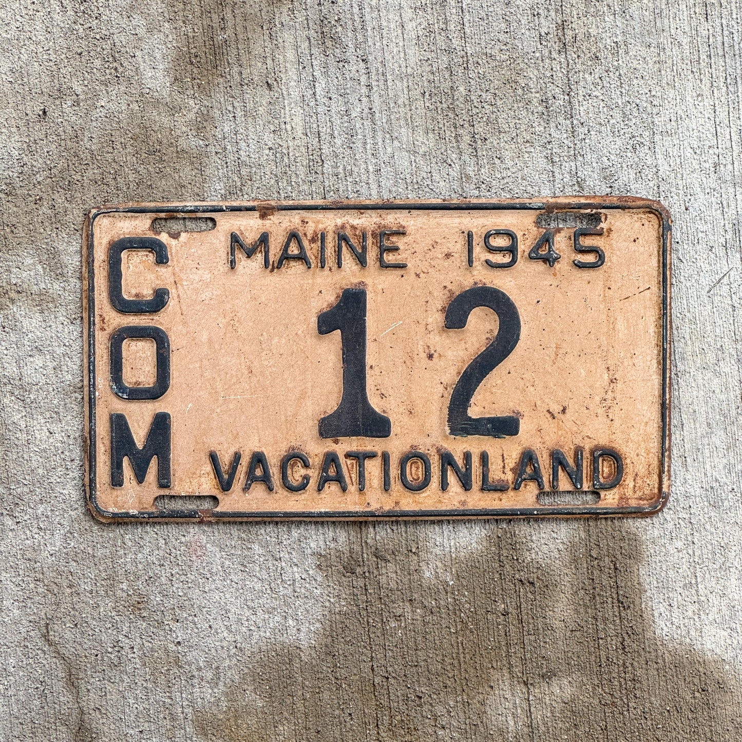 Photo of a 1945 Maine Commercial License Plate Auto Tag Garage Decor Vintage Low Number Two Digit 12 with original patina