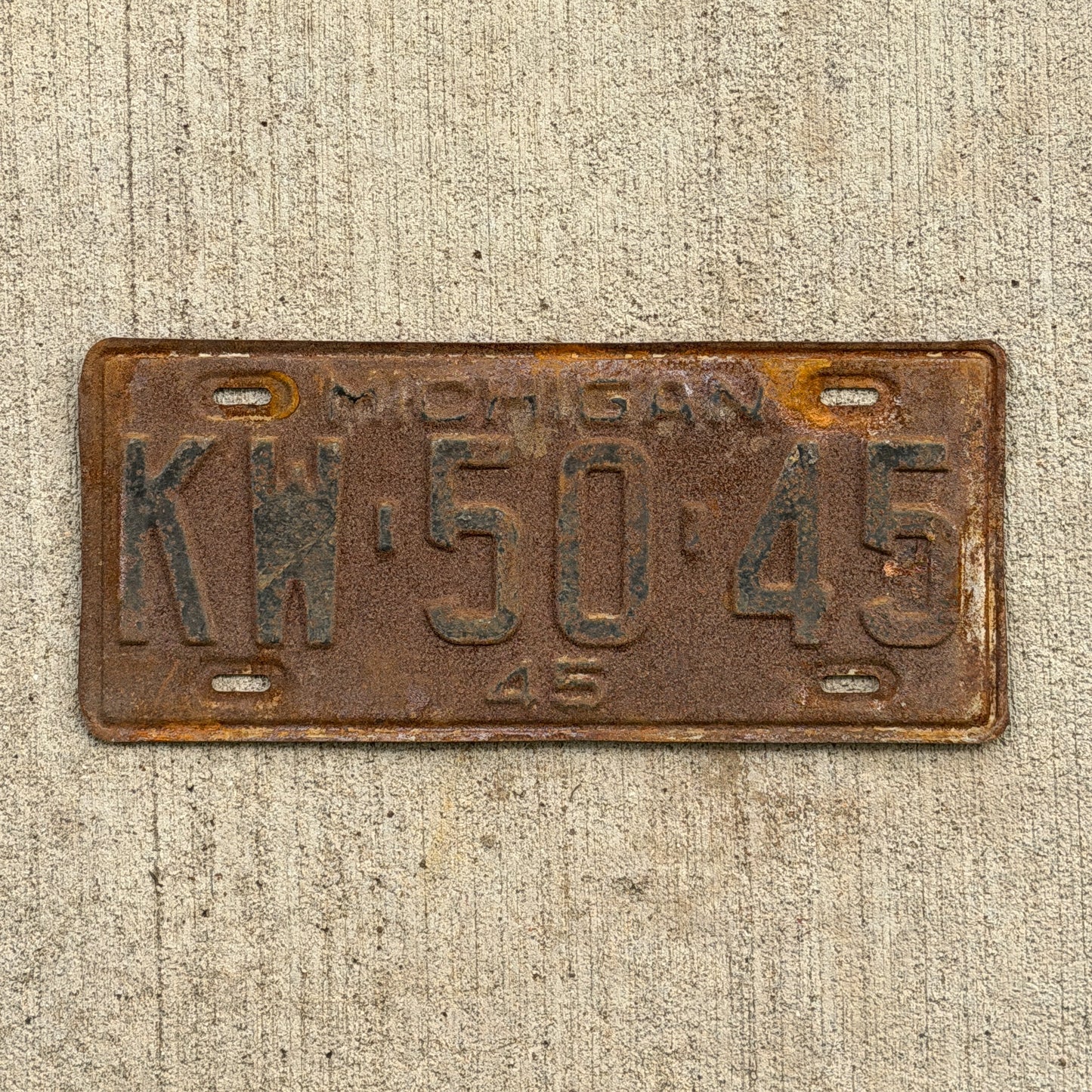 Photo of a 1945 Michigan License Plate Auto Tag Garage Decor Vintage KW 50 45 with original patina