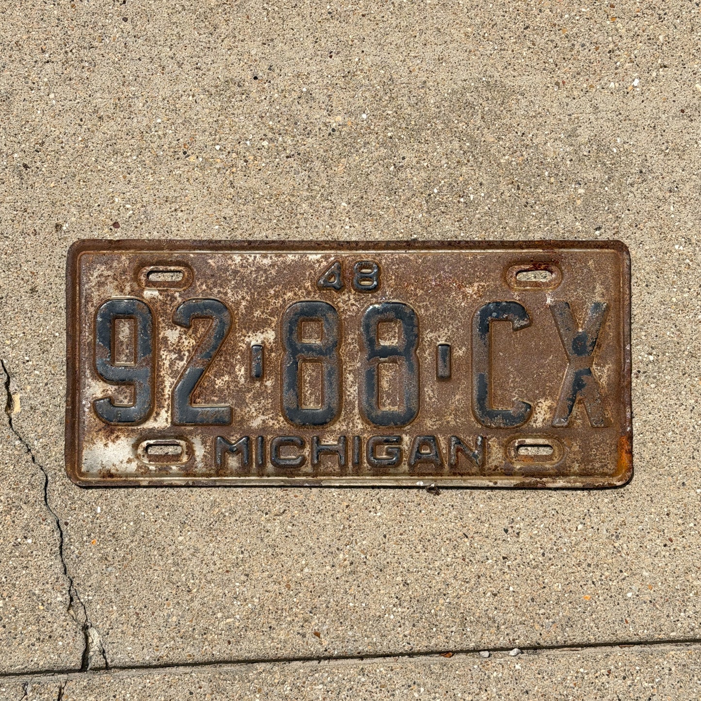 Photo of a 1948 Michigan Commercial License Plate Auto Tag Garage Decor Vintage 92 88 CX with original patina