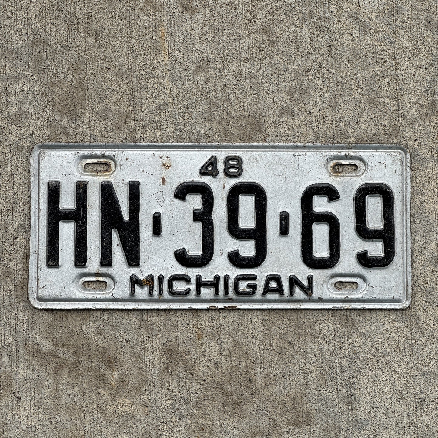 Photo of a 1948 Michigan License Plate Auto Tag Garage Decor Vintage HN 39 69 with original patina