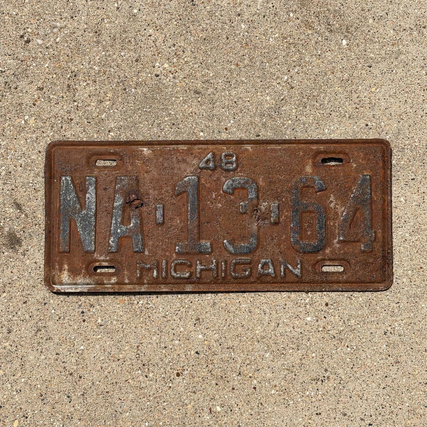 Photo of a 1948 Michigan License Plate Auto Tag Garage Decor Vintage NA 13 64 with original patina