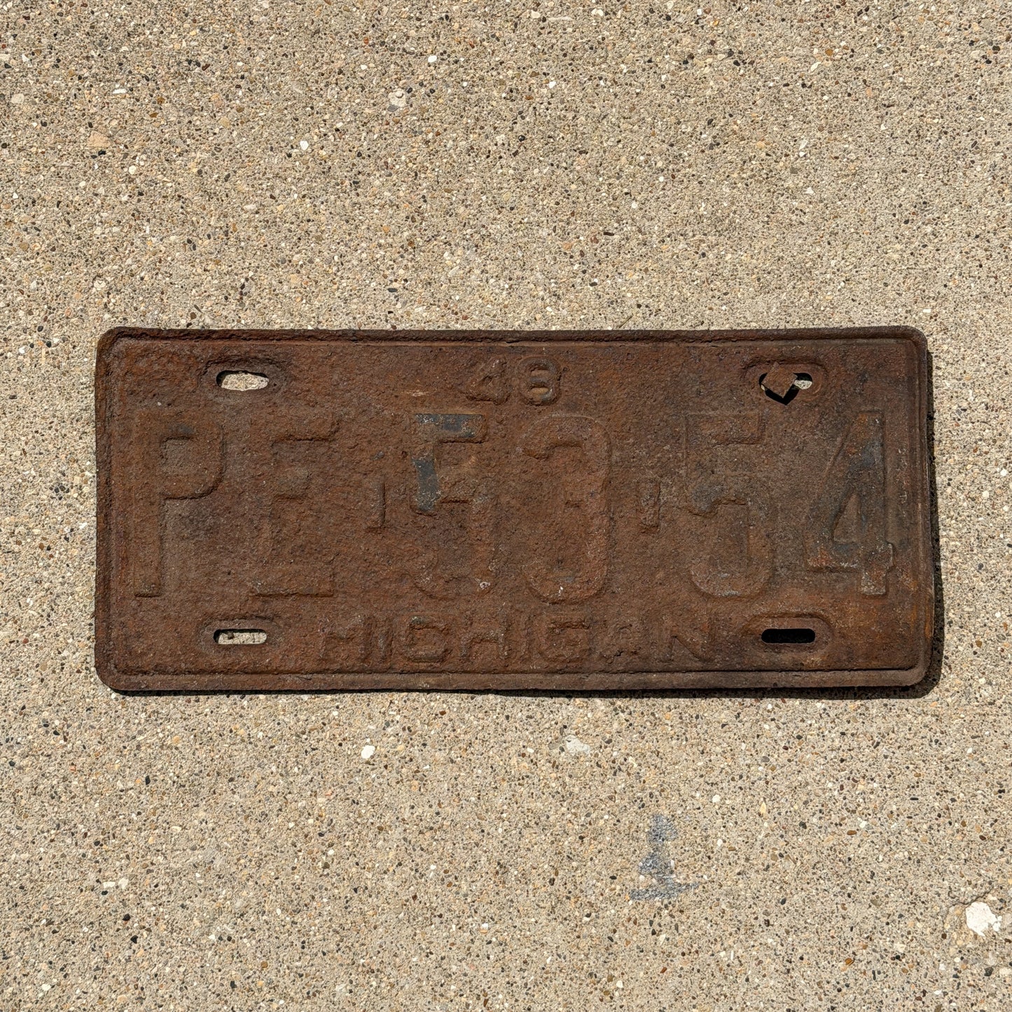 Photo of a 1948 Michigan License Plate Auto Tag Garage Decor Vintage PE 53 54 with original patina