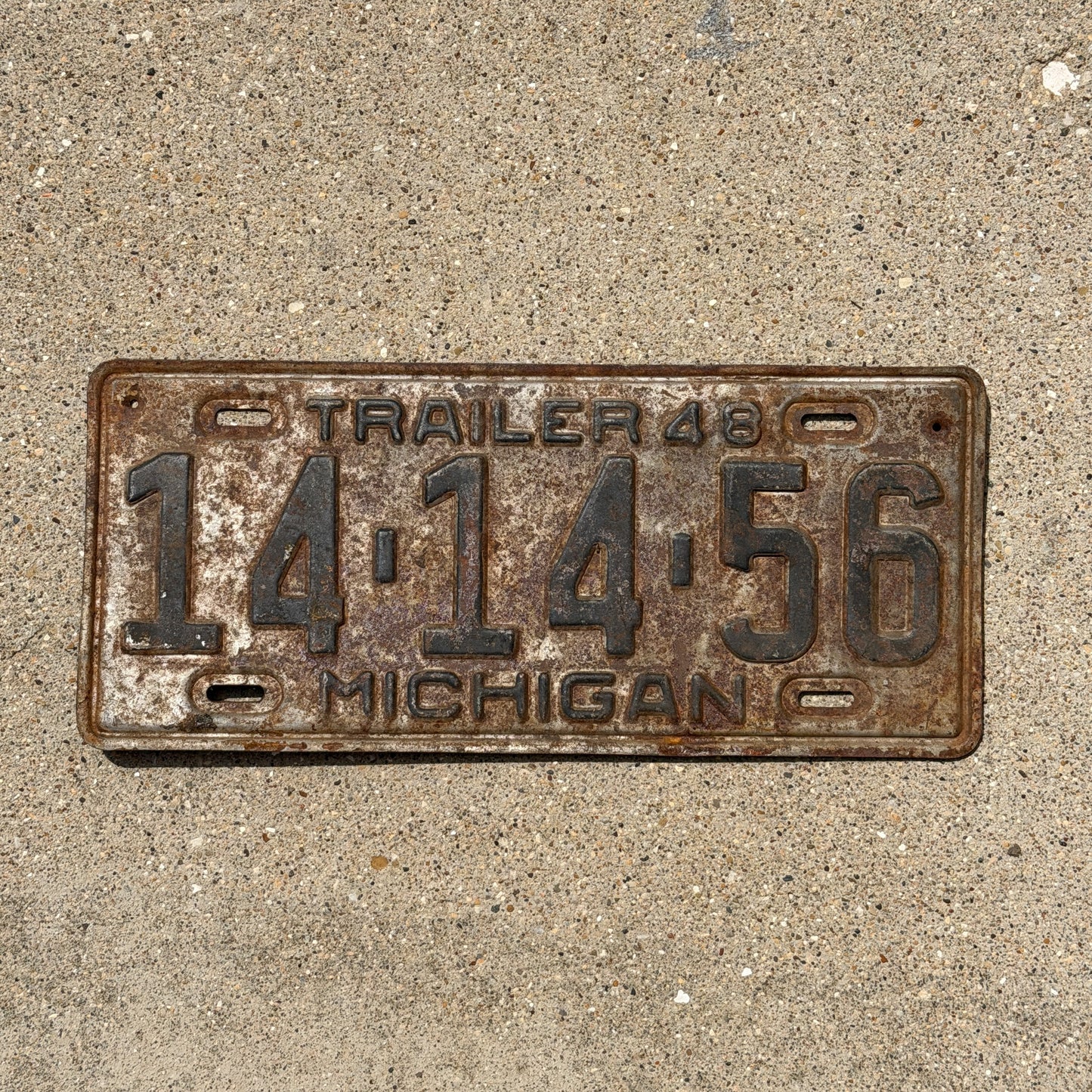 Photo of a 1948 Michigan Trailer License Plate Auto Tag Garage Decor Vintage 14 14 56 with original patina