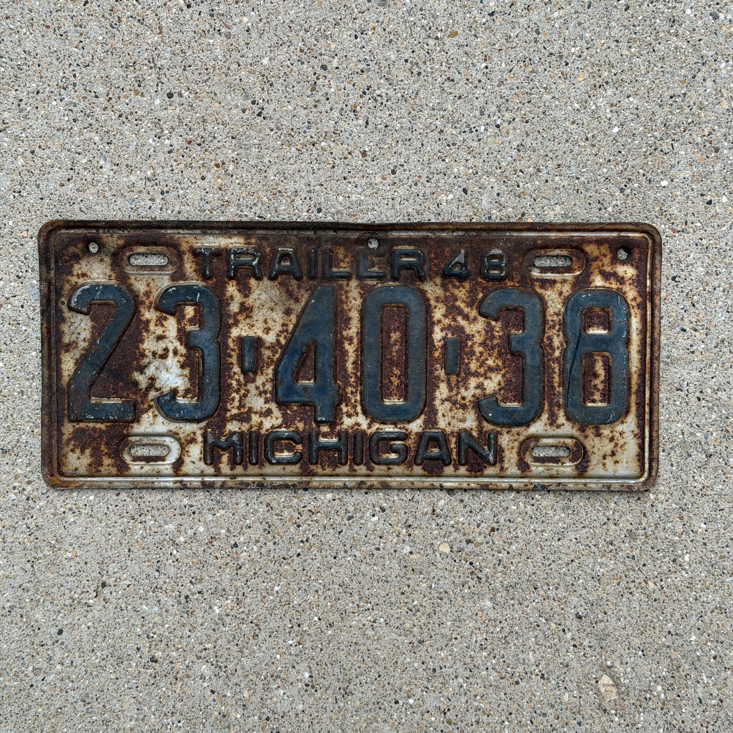 Photo of a 1948 Michigan Trailer License Plate Auto Tag Garage Decor Vintage 23 40 38 with original patina