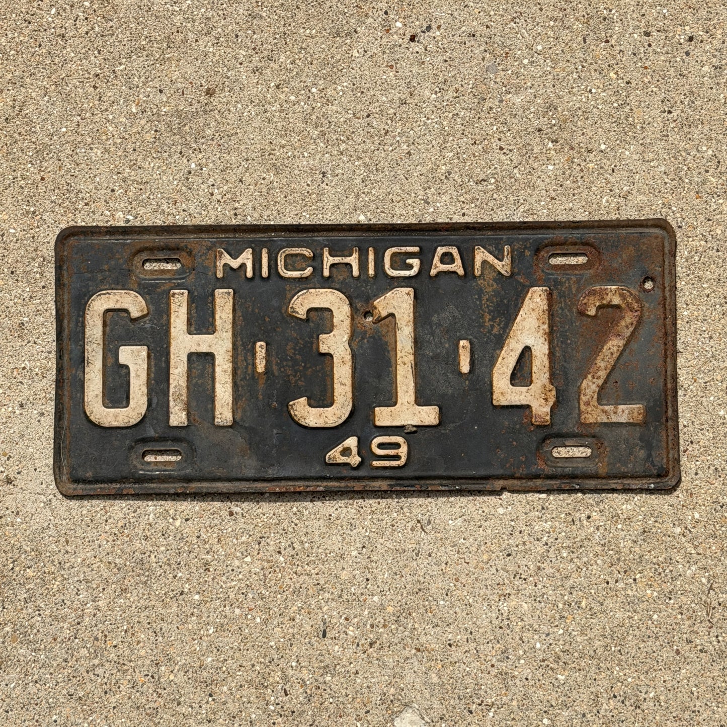 Photo of a 1949 Michigan License Plate Auto Tag Garage Decor Vintage GH 31 42 with original patina