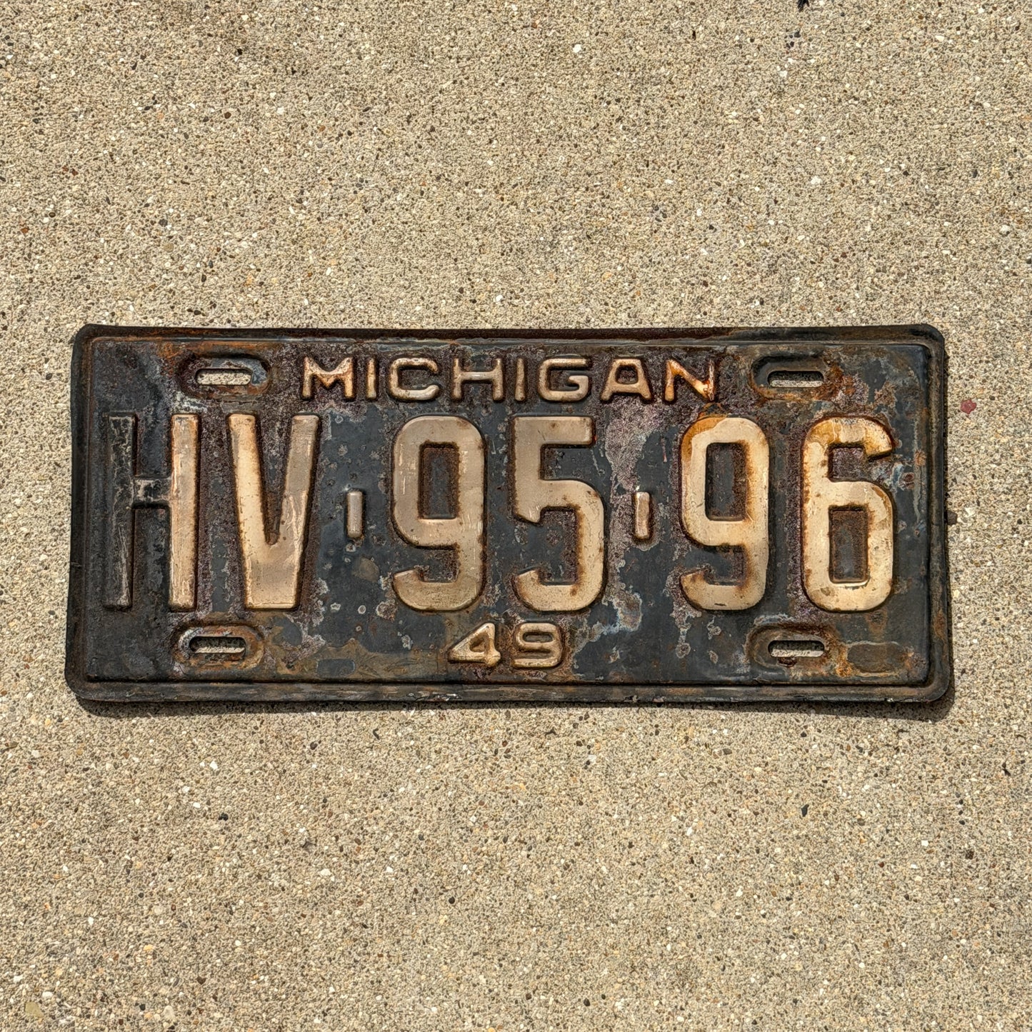 Photo of a 1949 Michigan License Plate Auto Tag Garage Decor Vintage HV 95 96 with original patina