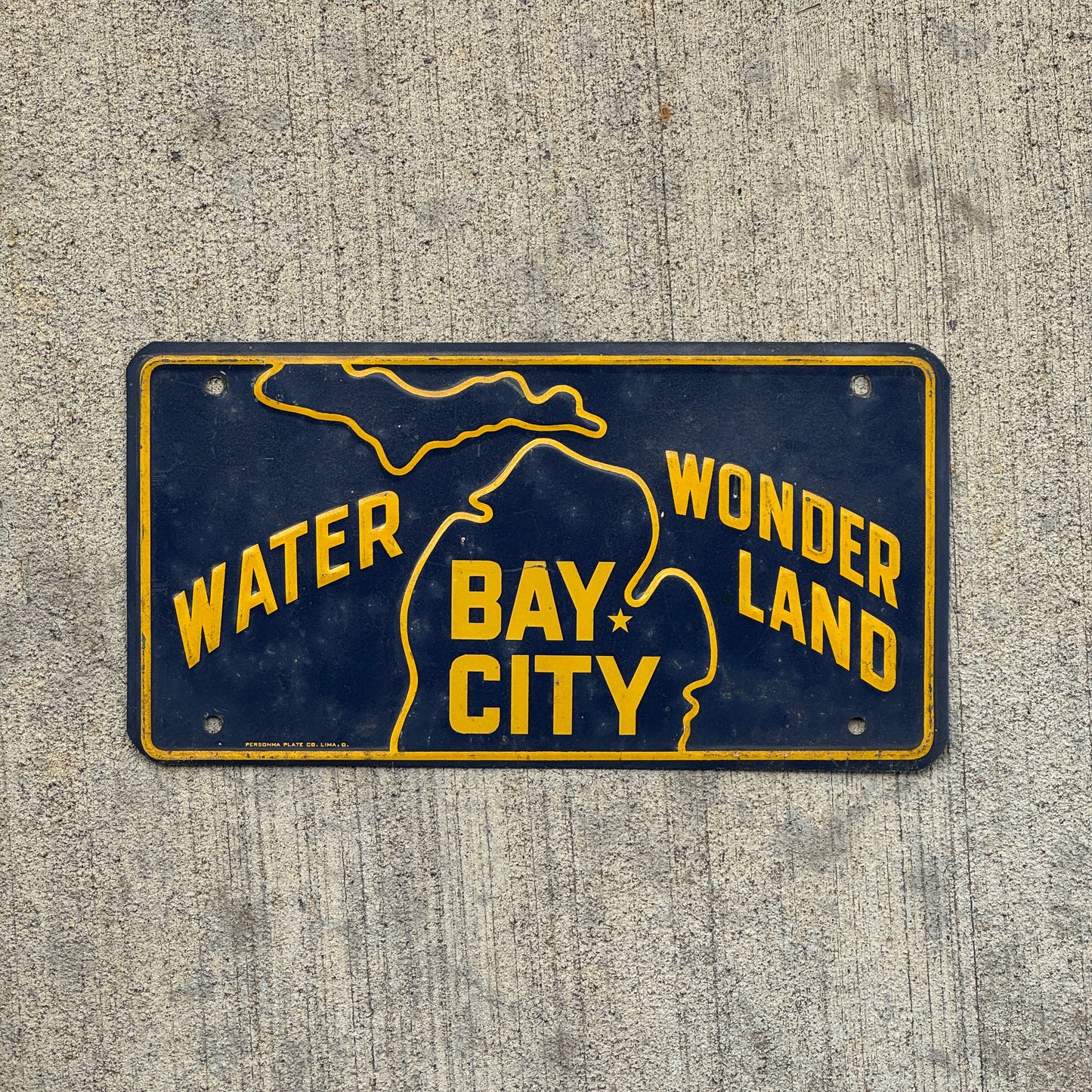 Photo of a 1950 Era Bay City Michigan Booster License Plate Auto Tag Garage Decor Vintage Water Wonderland Metal with original patina