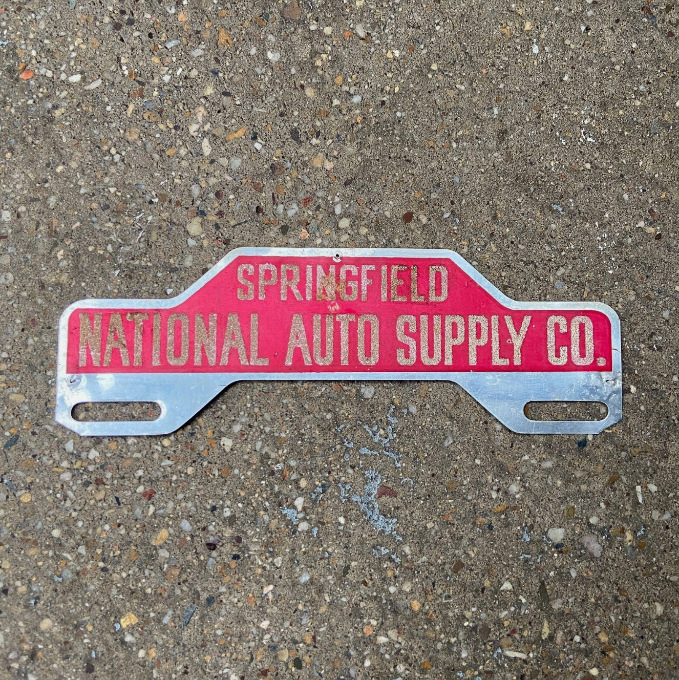 Photo of a 1950 Era Springfield National Auto Supply Co License Plate Topper Auto Tag Garage Decor Vintage Reflective Smaltz Paint with original patina