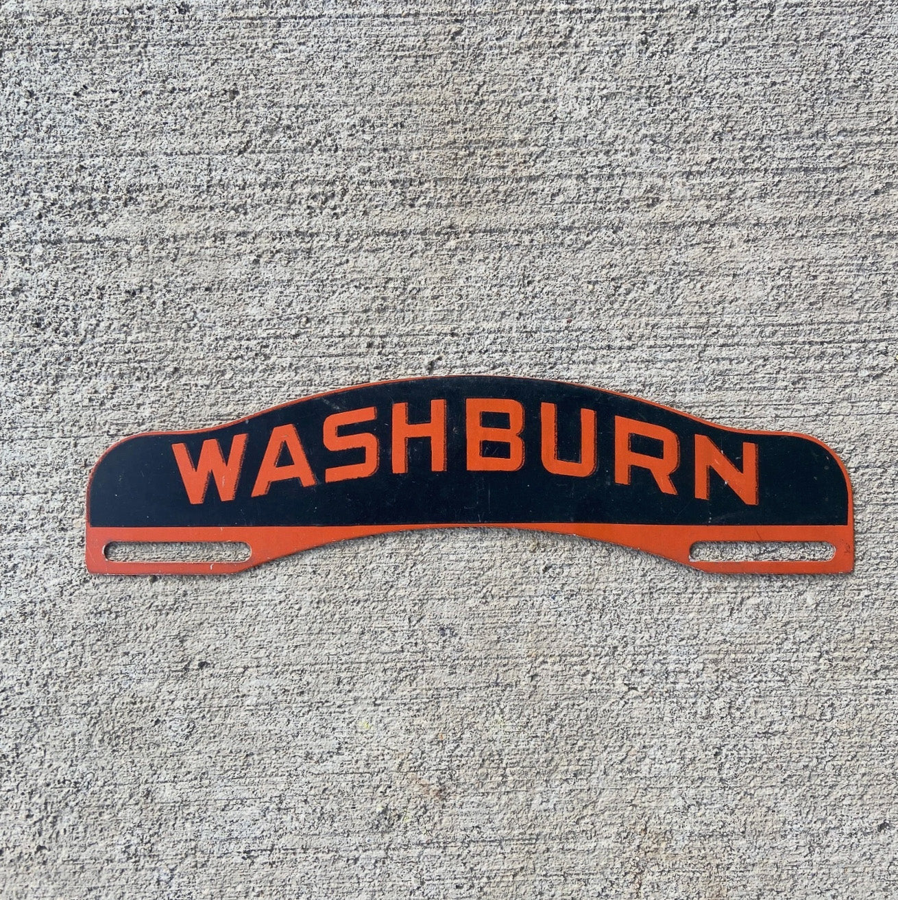Photo of a 1950 Era Washburn Wisconsin License Plate Topper Auto Tag Garage Decor Vintage Black Orange Metal Garage Decor Wisconsin? with original patina