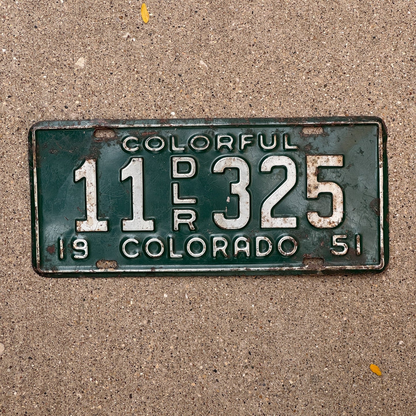 Photo of a 1951 Colorado Dealer License Plate Auto Tag Garage Decor Vintage 11 325 with original patina