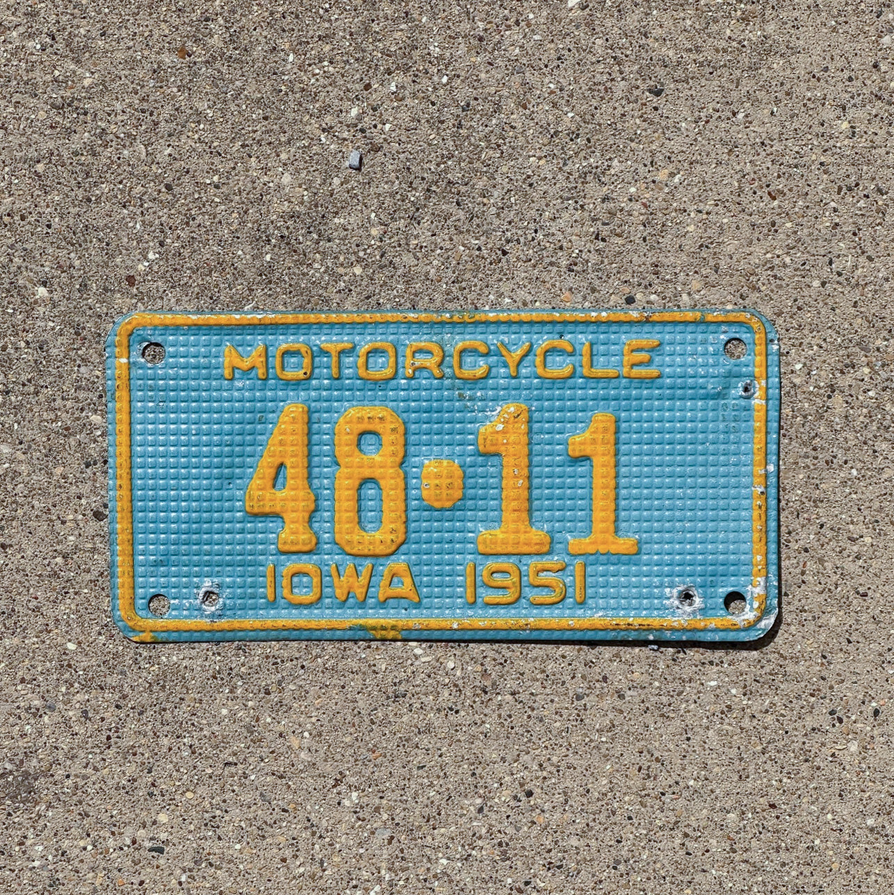 Photo of a 1951 Iowa Motorcycle License Plate Auto Tag Garage Decor Vintage Waffle Style Low Number Two Digit Iowa County 48 11 with original patina