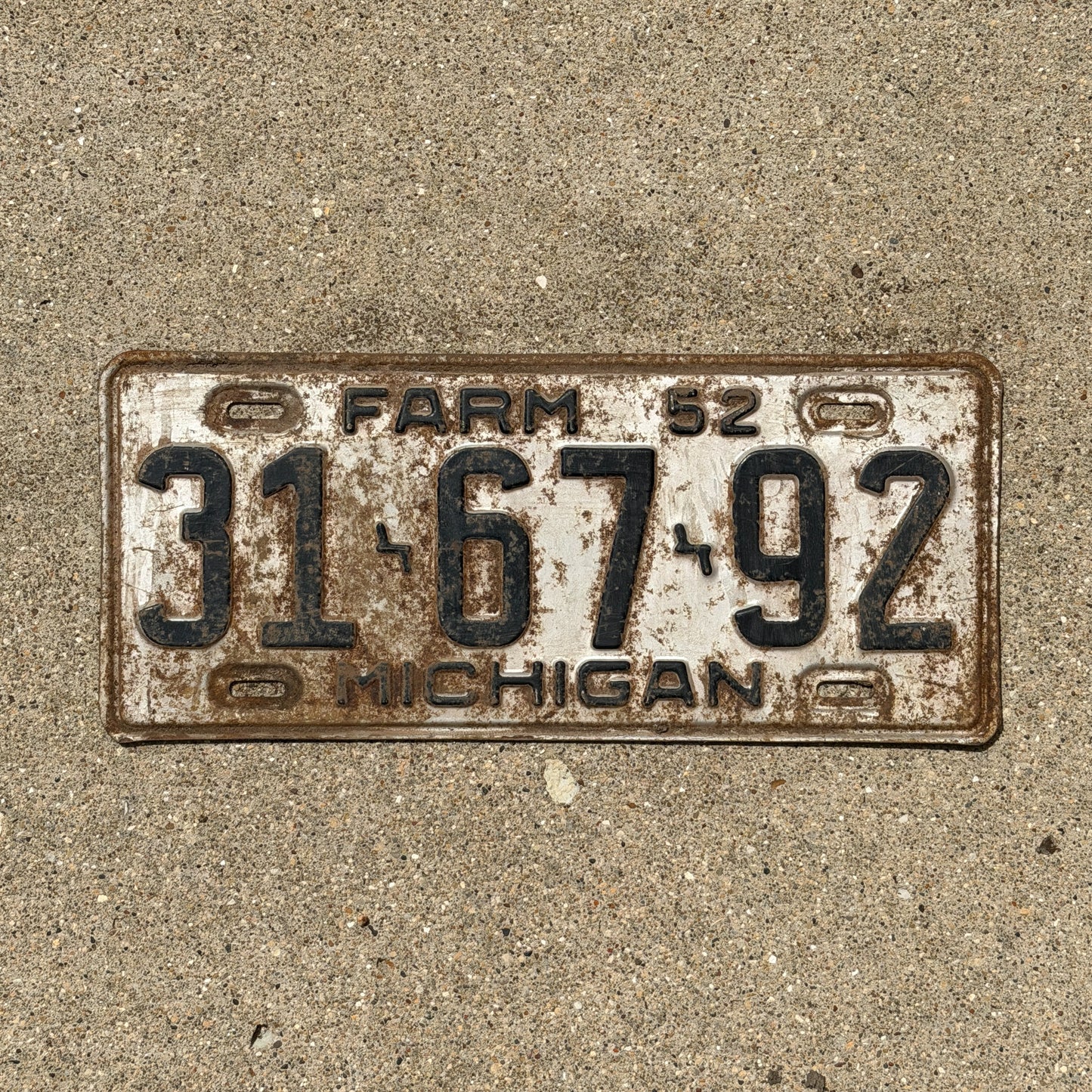 Photo of a 1952 Michigan Farm License Plate Auto Tag Garage Decor Vintage 31 67 92 with original patina