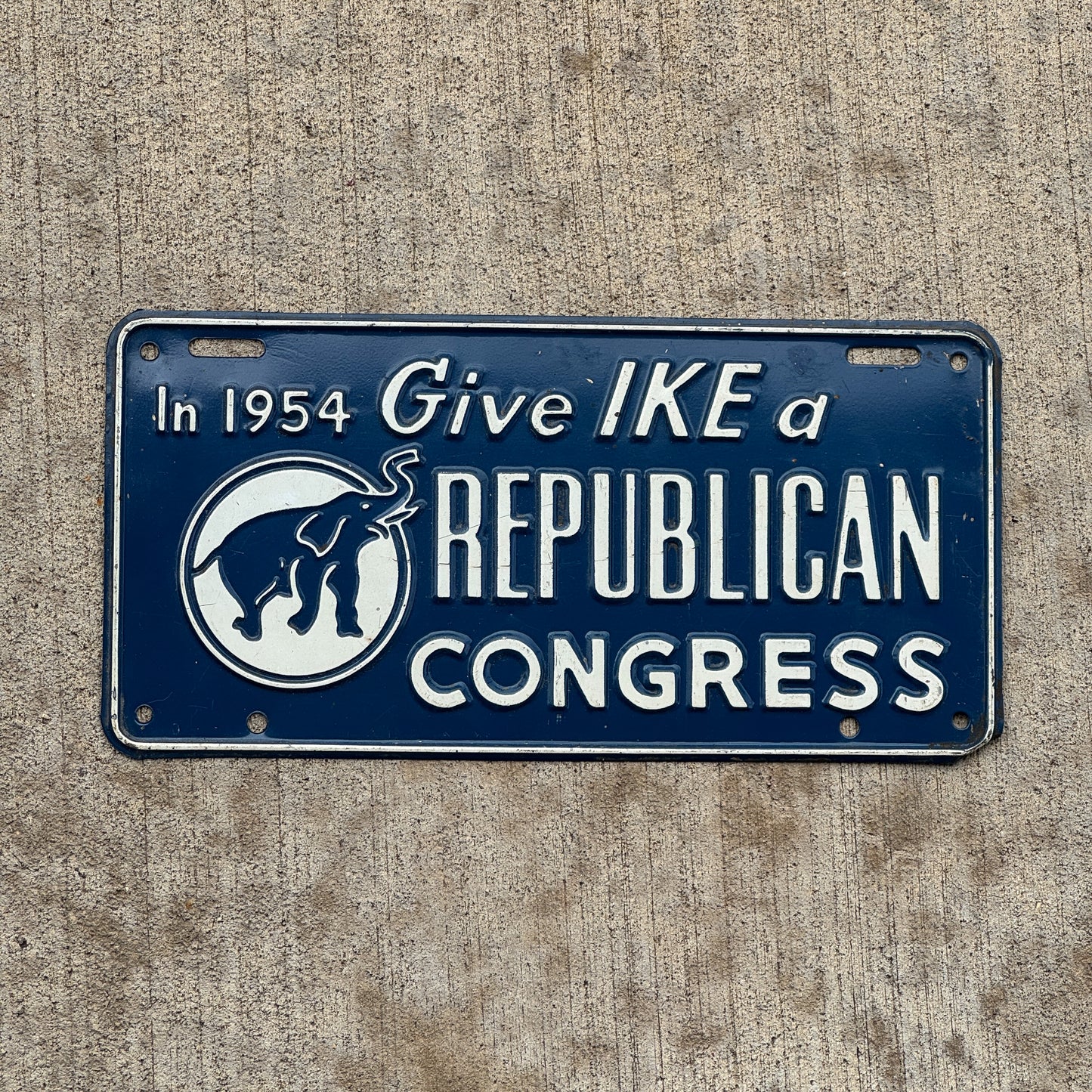 Photo of a 1954 Give Ike a Republican Congress Booster License Plate Auto Tag Garage Decor Vintage Eisenhower Politics Political with original patina