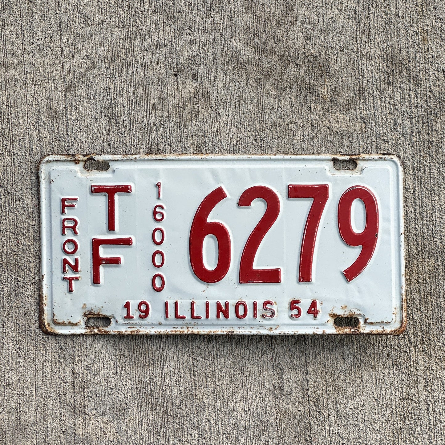 Photo of a 1954 Illinois Truck Mileage Tax Front License Plate Auto Tag Garage Decor Vintage 16000 LBS TF 6279 with original patina