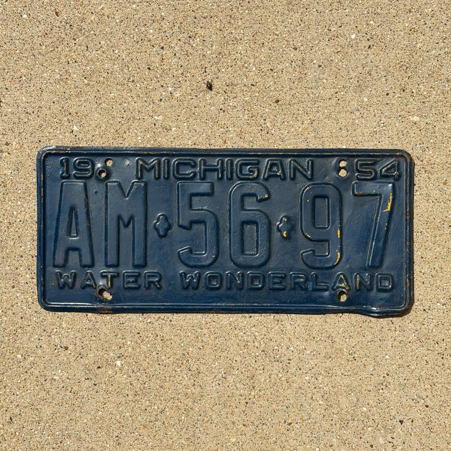 Photo of a 1954 Michigan License Plate Auto Tag Garage Decor Vintage AM 56 97 with original patina