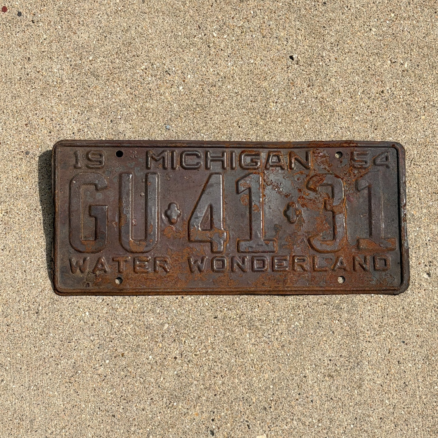 Photo of a 1954 Michigan License Plate Auto Tag Garage Decor Vintage GU 41 31 with original patina