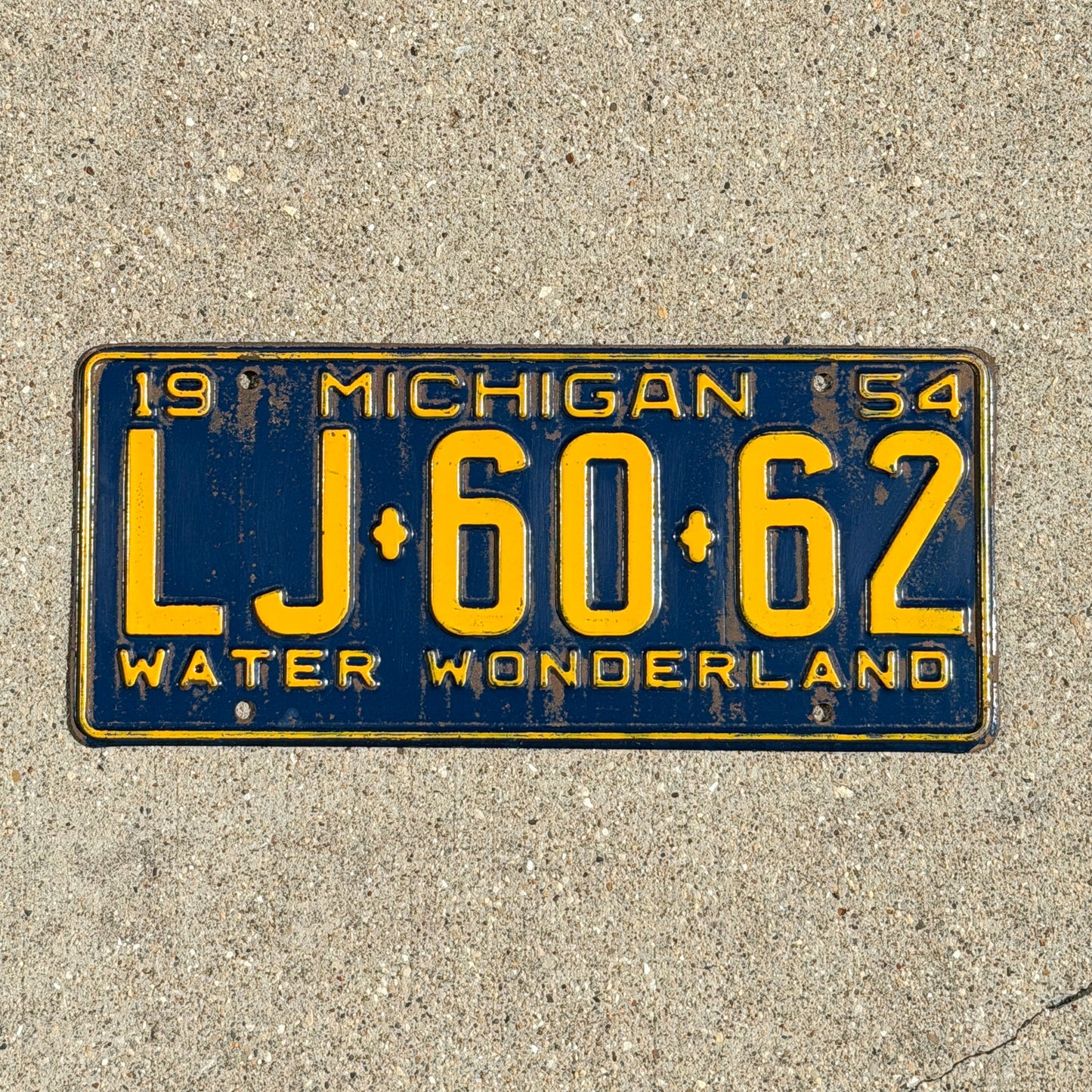 Photo of a 1954 Michigan License Plate Auto Tag Garage Decor Vintage LJ 60 62 with original patina