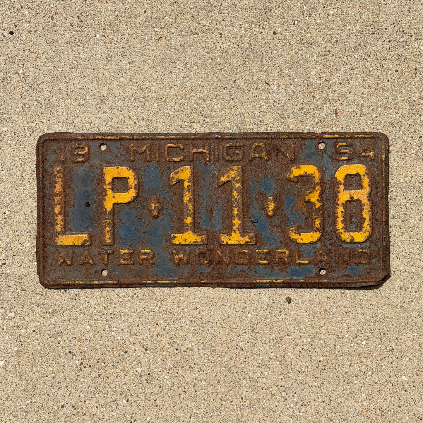 Photo of a 1954 Michigan License Plate Auto Tag Garage Decor Vintage LP 11 38 with original patina