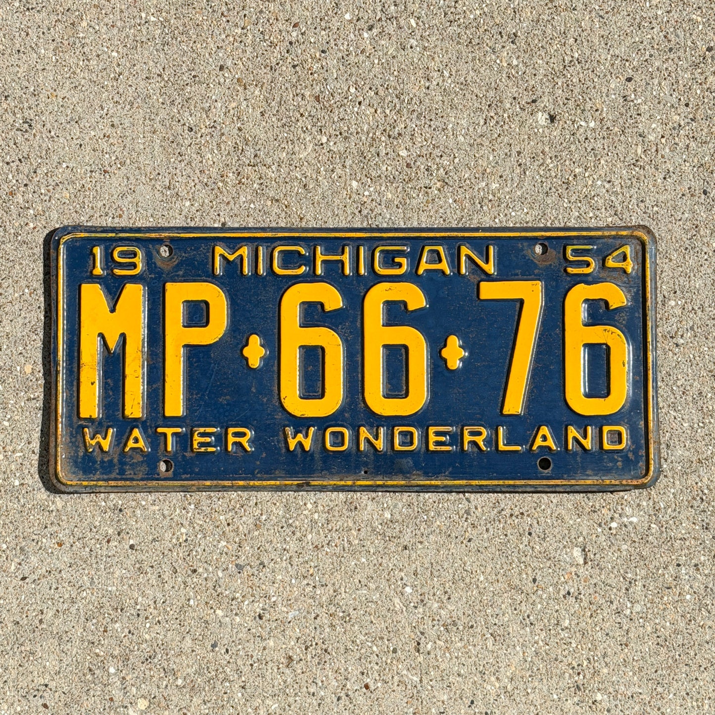 Photo of a 1954 Michigan License Plate Auto Tag Garage Decor Vintage MP 66 76 with original patina