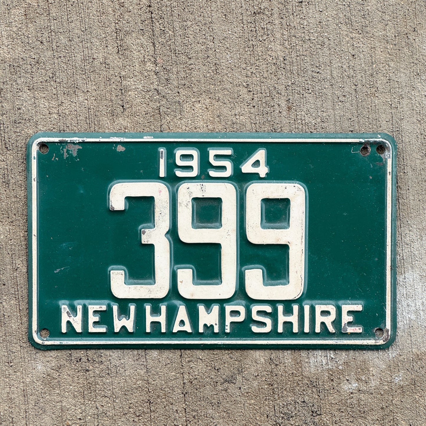 Photo of a 1954 New Hampshire License Plate Auto Tag Garage Decor Vintage Low Number Three Digit 399 with original patina