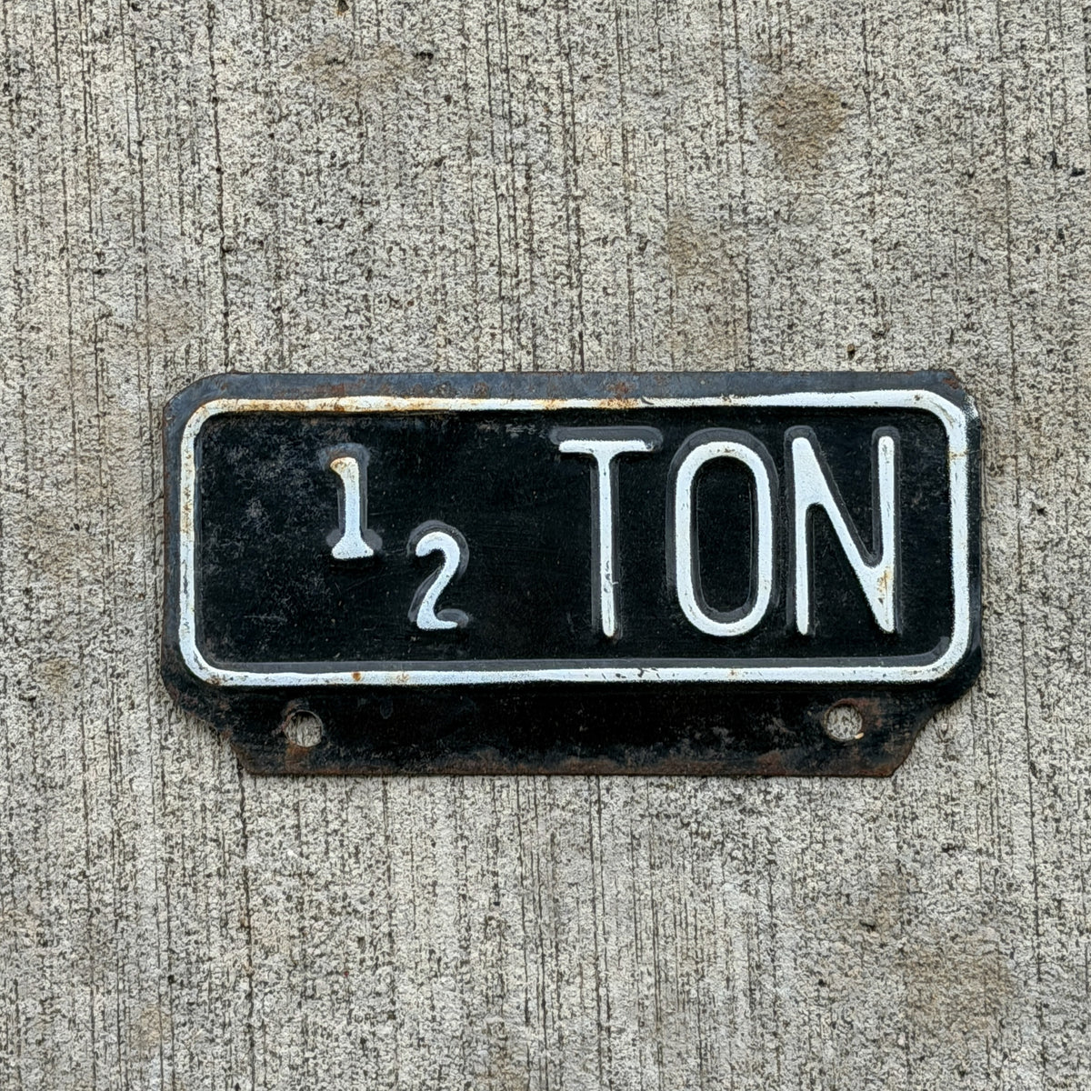 Photo of a 1955 Kansas Truck License Plate Auto Tag Garage Decor Vintage 1/2 Ton Weight Supplementary Topper with original patina