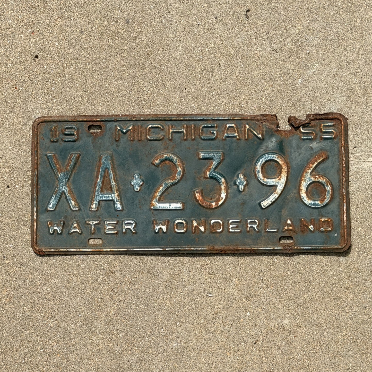 Photo of a 1955 Michigan License Plate Auto Tag Garage Decor Vintage XA 23 96 with original patina