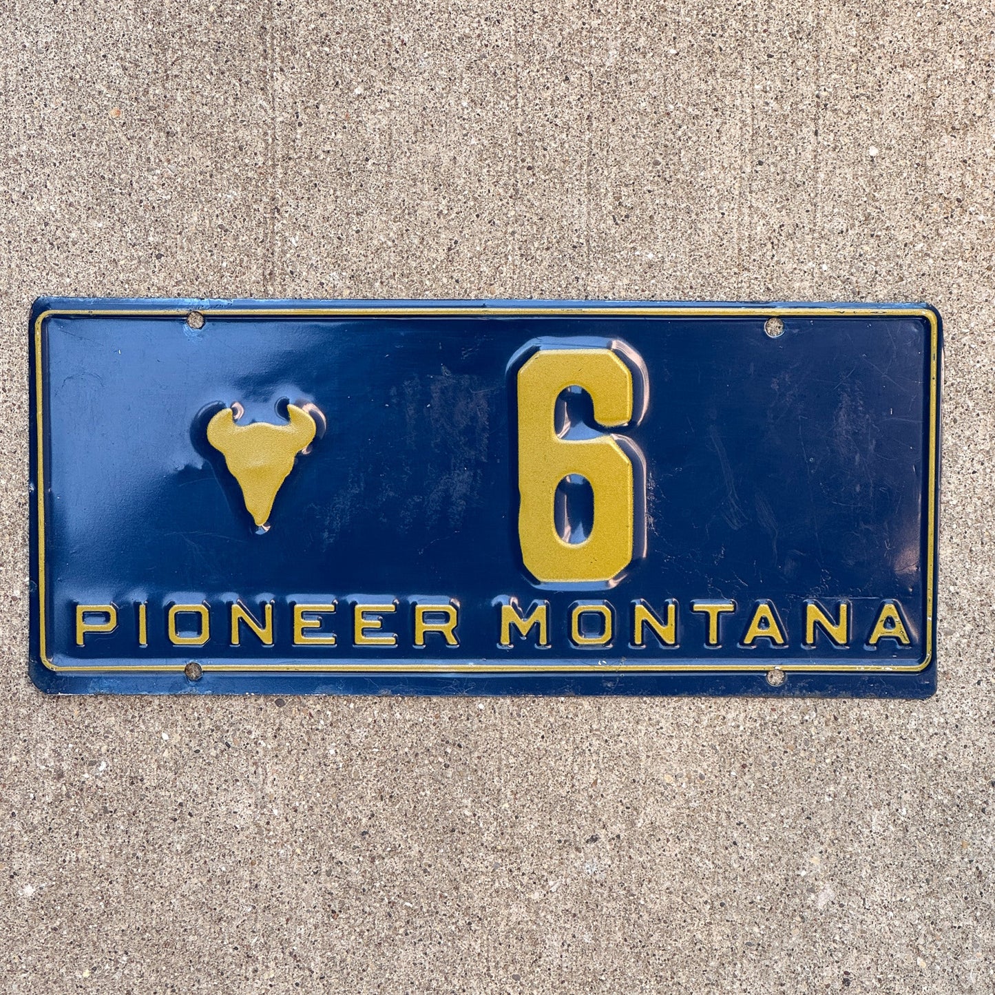 Photo of a 1955 Montana Pioneer License Plate Auto Tag 1 Garage Decor Bison Head Low Number Single Digit 6 with original patina