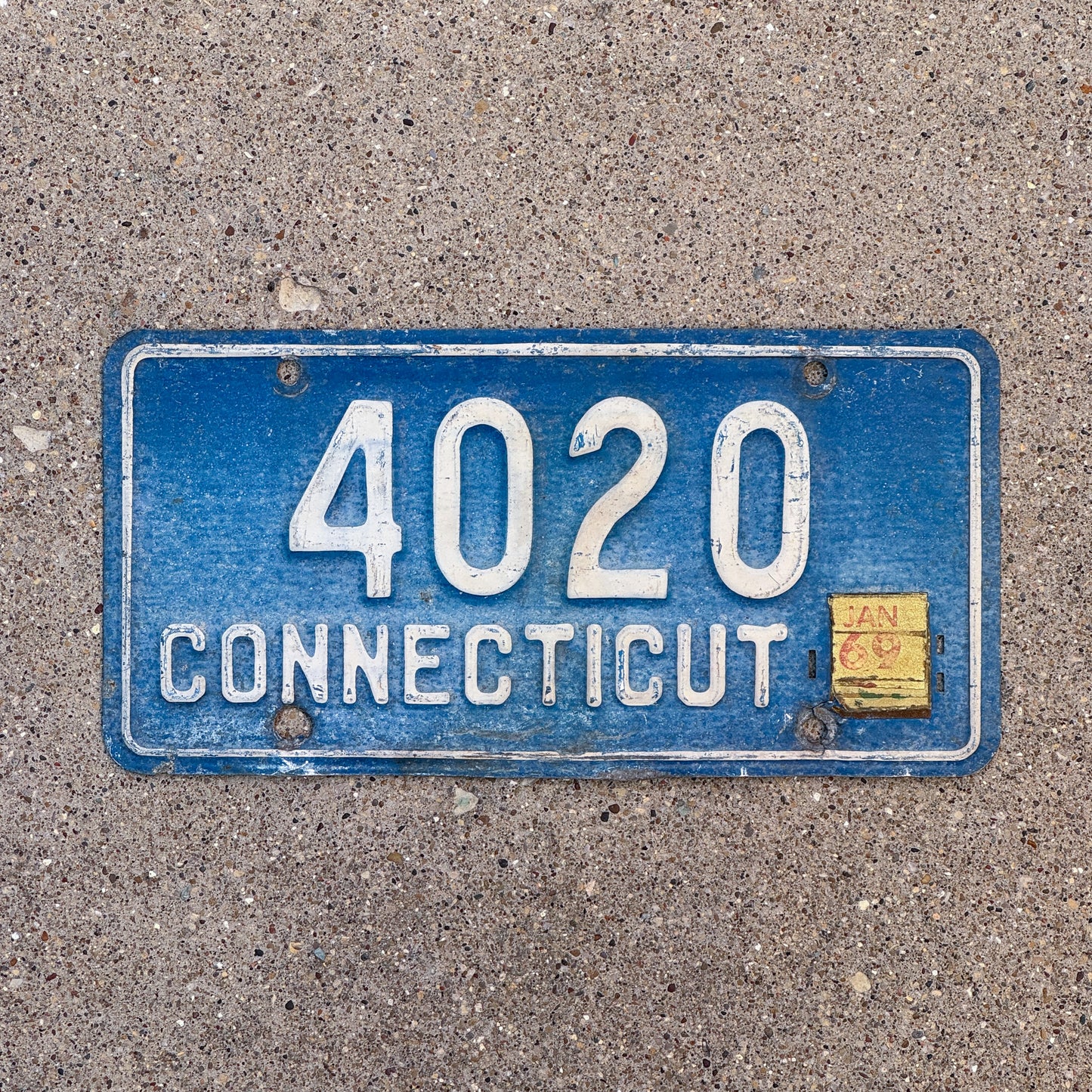 Photo of a 1957 1969 Connecticut License Plate Auto Tag Garage Decor Vintage 1963 Reissue Low Number Four Digit 4020 with original patina