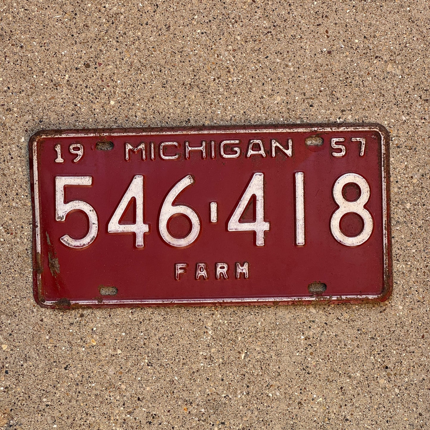 Photo of a 1957 Michigan Farm License Plate Auto Tag Garage Decor Vintage 546 418